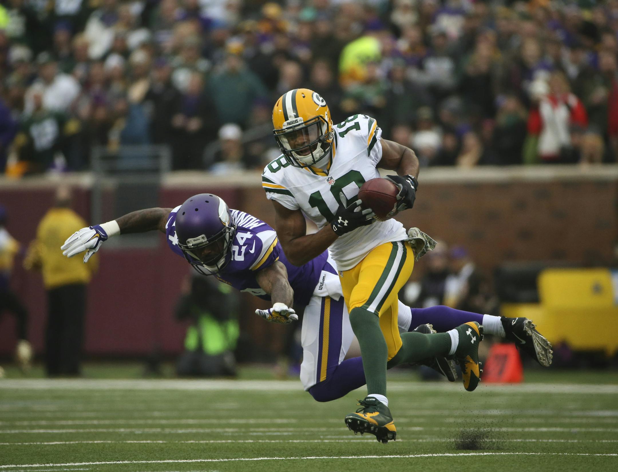 Green Bay Packers wide receiver Randall Cobb (18) caught a first quarter pass in front of Minnesota Vikings cornerback Captain Munnerlyn (24) Sunday afternoon at TCF Bank Stadium in Minneapolis.