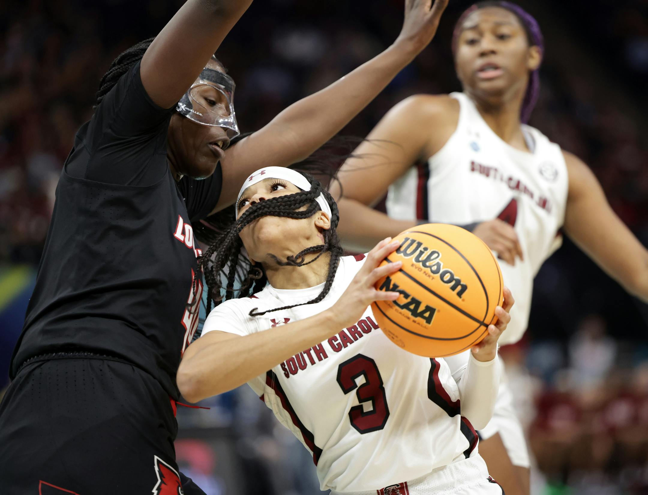South Carolina guard Destanni Henderson drives against Louisville forward Olivia Cochran.