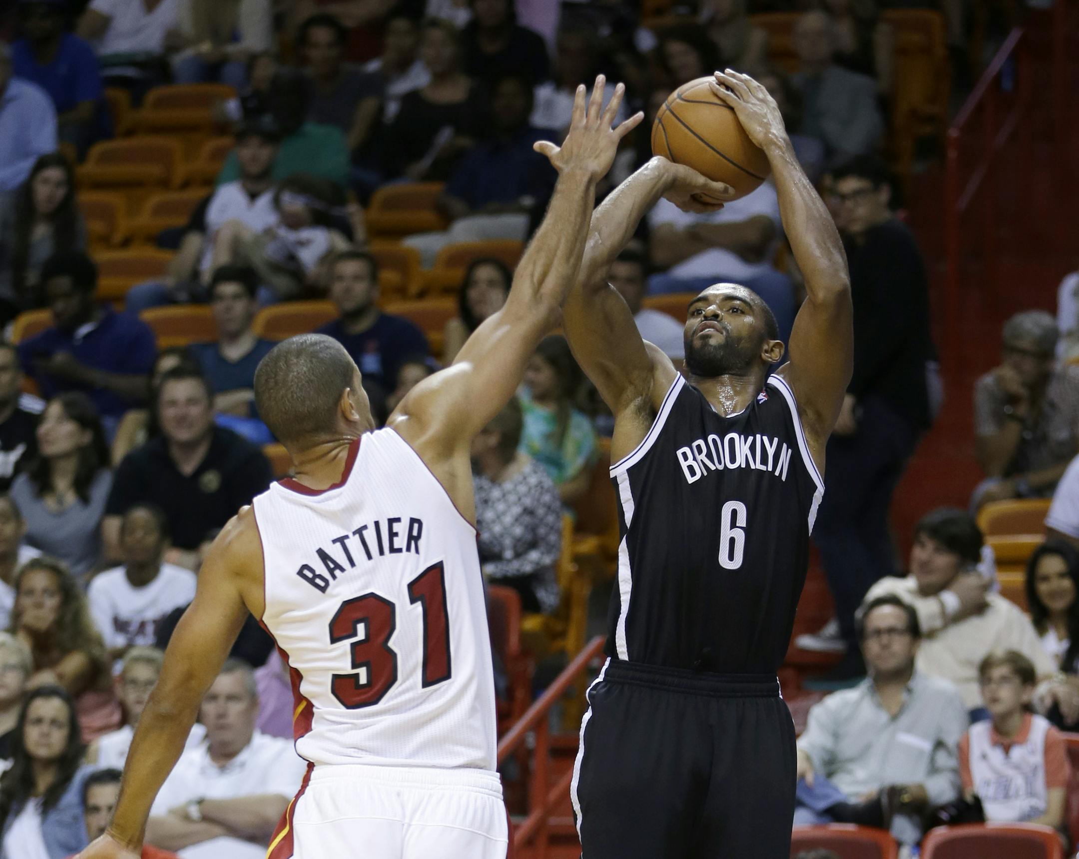 Brooklyn Nets shooting guard Alan Anderson (6) prepares to shoot against Miami Heat small forward Shane Battier (31) in the fourth quarter of an NBA preseason basketball game, Friday, Oct. 25, 2013, in Miami. The Nets won 108-87. (AP Photo/Alan Diaz) ORG XMIT: FLAD106