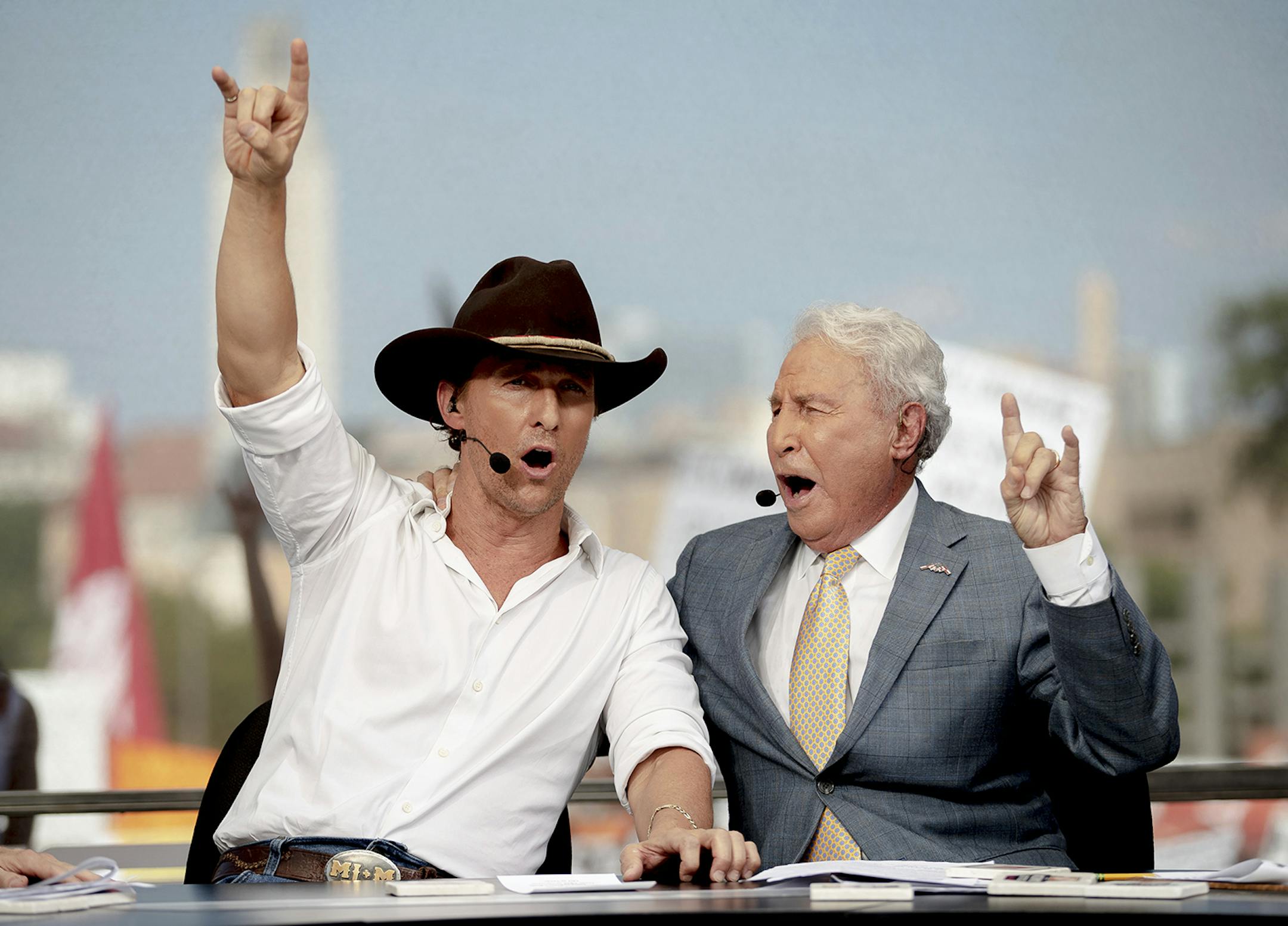 Matthew McConaughey holds up the "Hook 'Em Horns" sign with College GameDay host Lee Cors during ESPN's College GameDay broadcast on Saturday, Sept. 7, 2019, in Austin, Texas. (Nick Wagner/Austin American-Statesman via AP) ORG XMIT: TXAUS602