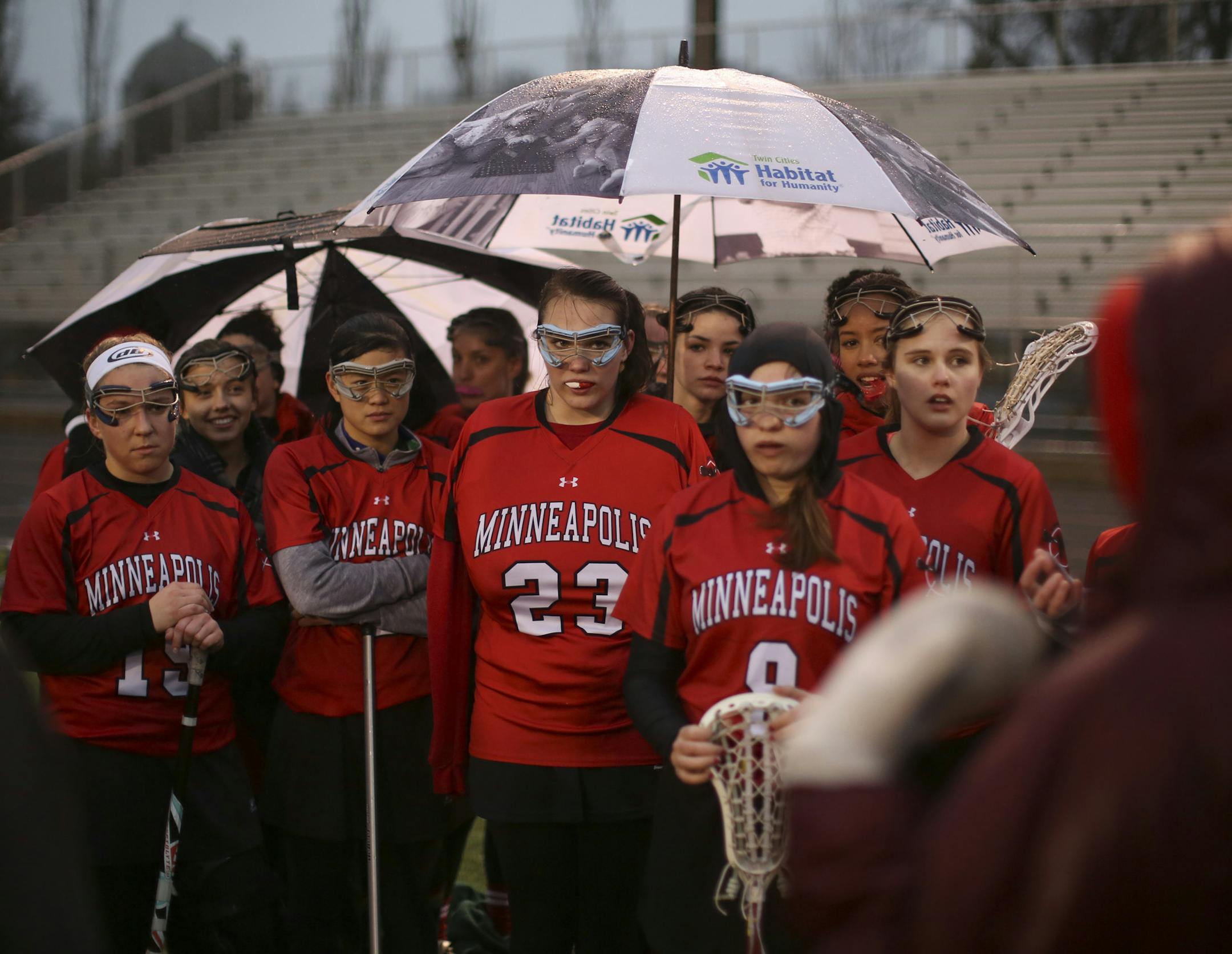 The Minneapolis lacrosse team listened to coaches Wednesday as they braved a cold, rainy outdoor game.