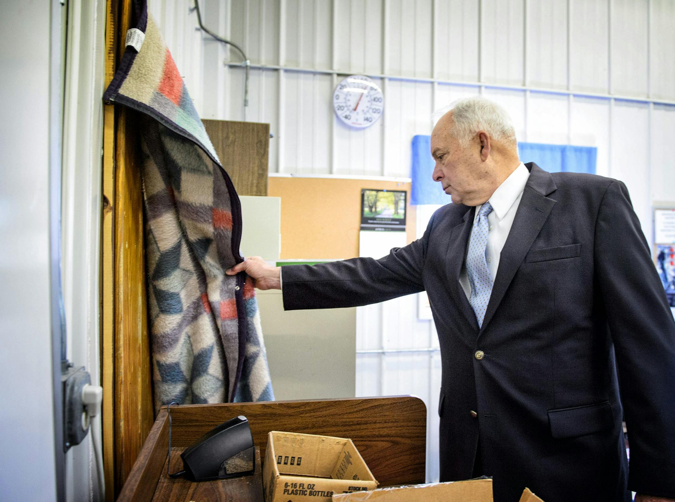 Rep John Kline lifted up a blanked draped over an uninsulated door used in an effort to keep out the cold in a building that was once used for a vocational auto body shop and never intended to be used as classroom space. The building has a leaky roof, poor insulation and an overburdened electrical system.