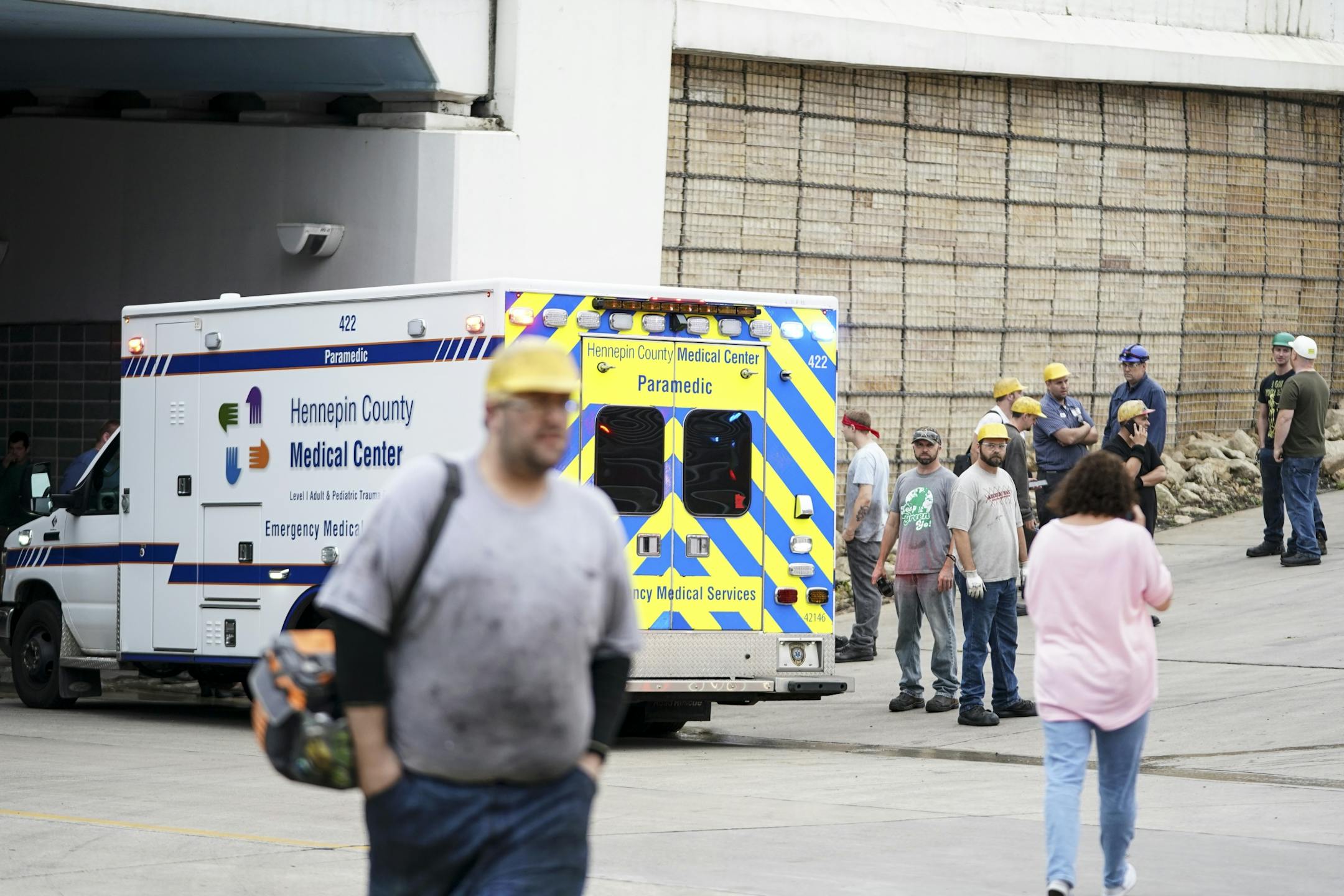 Workers waited by an ambulance after a fire and explosion which resulted in two serious injuries at Metal-Matic in Minneapolis.