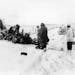 A group of men view of the wreckage of a Beechcraft Bonanza airplane in a snowy field outside of Clear Lake, Iowa, early February 1959. The crash, on 