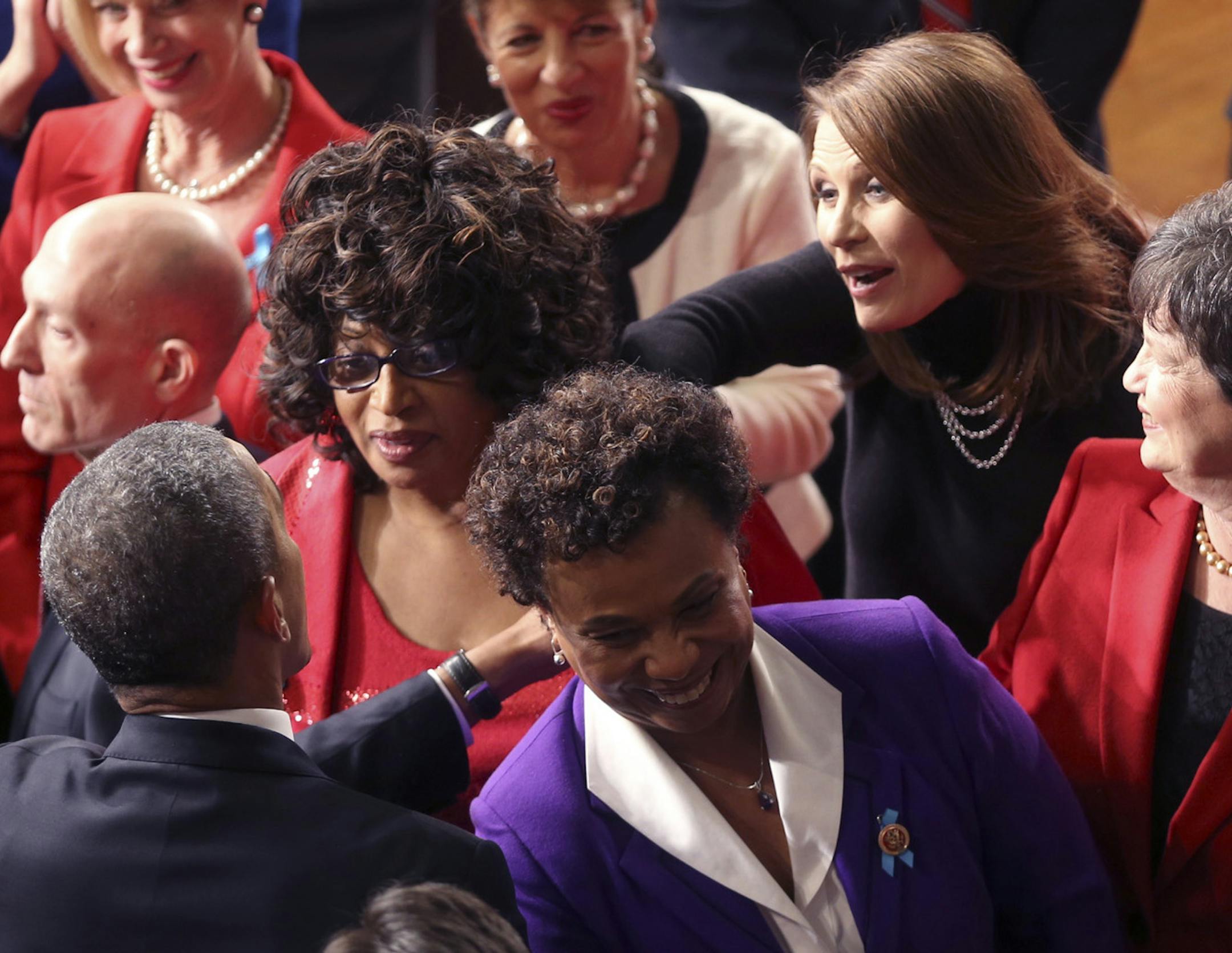 President Barack Obama reaches out to shake the hand of Rep. Michele Bachmann (R-Minn.), center, before delivering the State of the Union address at the Capitol Building in Washington, Jan. 28, 2014. (Doug Mills/The New York Times) ORG XMIT: MIN2014012822453148