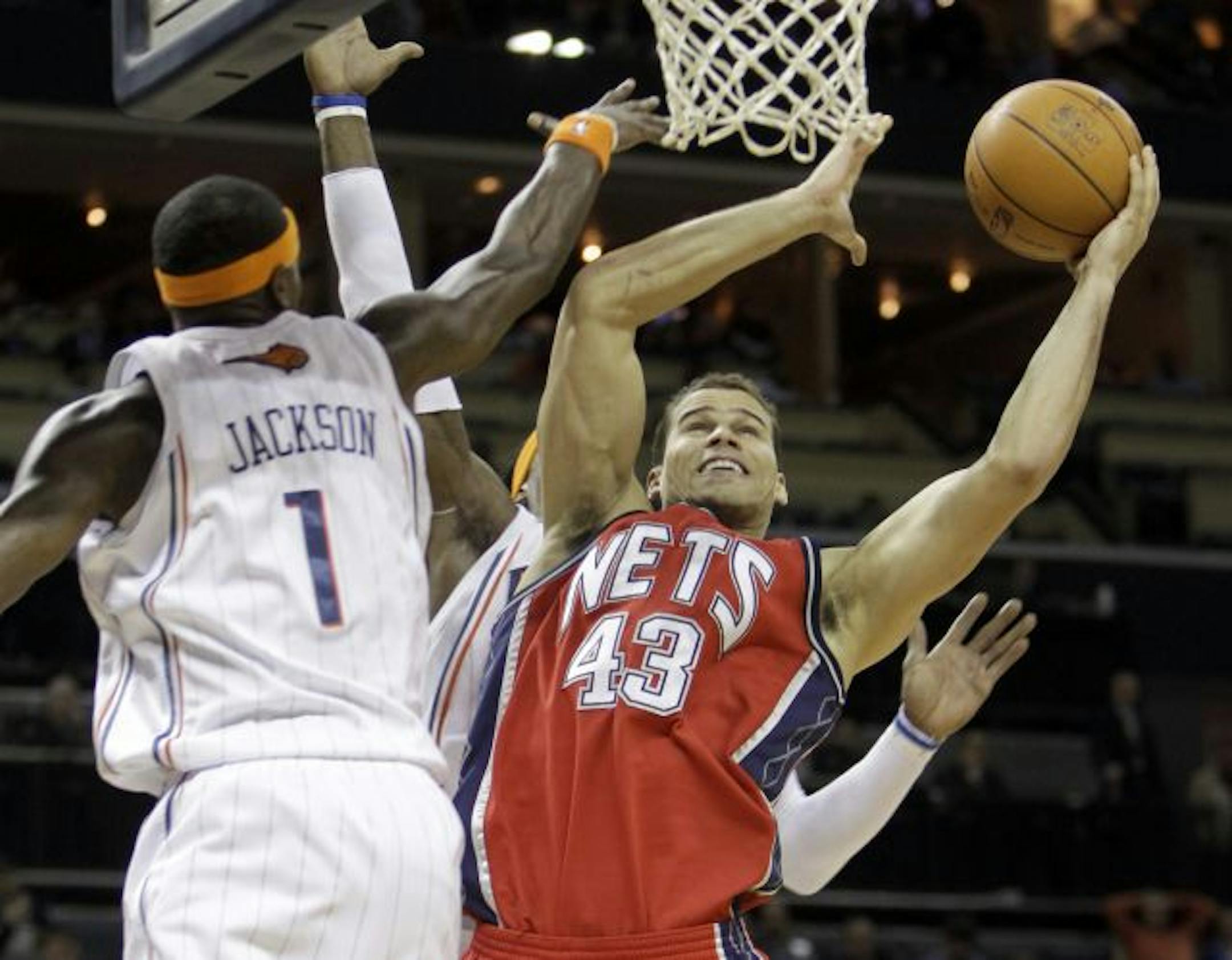 New Jersey Nets' Kris Humphries (43) shoots around Charlotte Bobcats' Stephen Jackson (1) in the second half of the Nets' 103-94 win in an NBA basketball game in Charlotte, N.C., Tuesday, Feb. 16, 2010.
