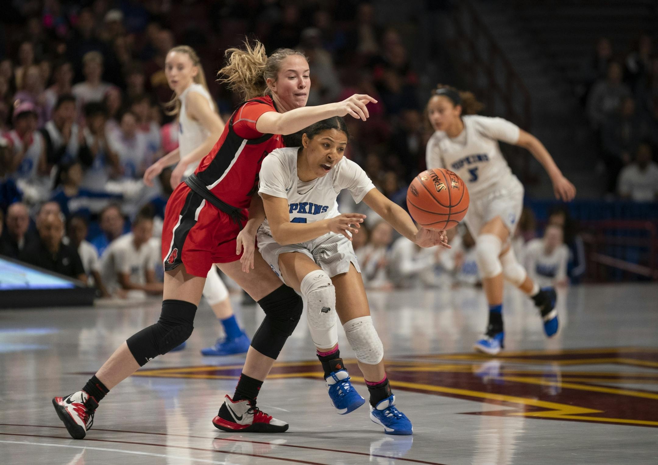 Hopkins guard Alayna Contreras (4) stripped the ball from Stillwater forward Lizzie Holder (22) during the second half of their Class 4A semifinal at the state girls' basketball tournament.