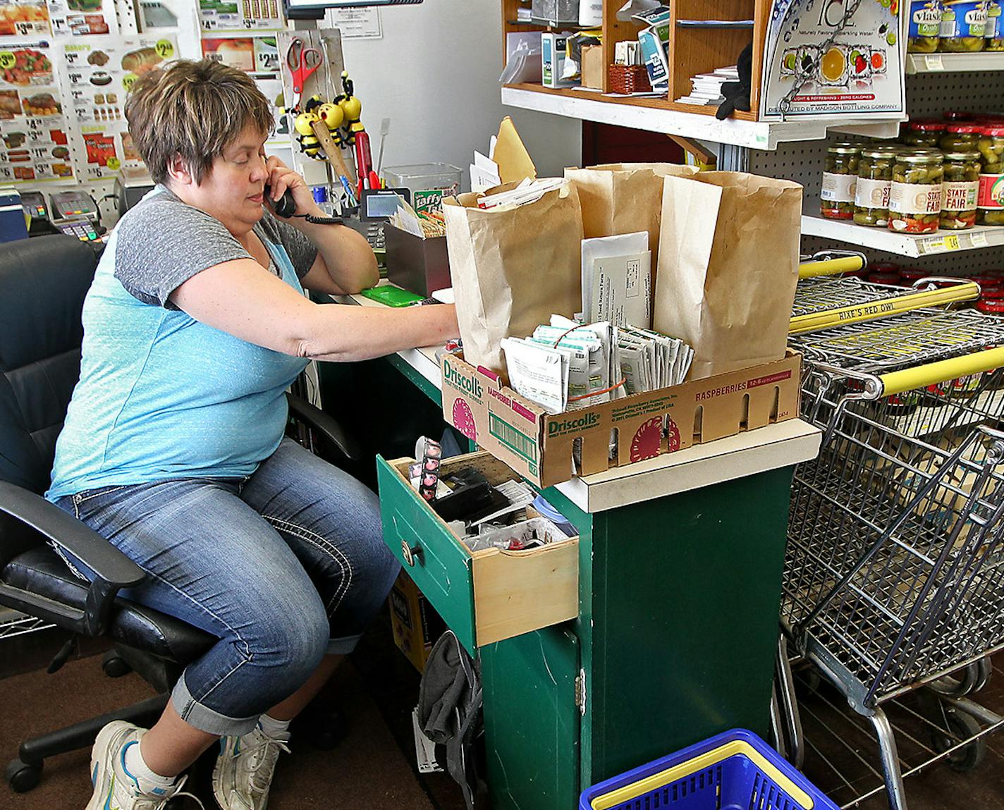 Bonnie Carlson took a phone order at her grocery store.