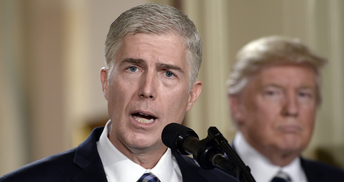 Supreme Court nominee Judge Neil M. Gorsuch speaks as President Donald Trump looks on in the East Room of the of White House in Washington, D.C., on Tuesday, Jan. 31, 2017. (Olivier Douliery/Abaca Press/TNS) ORG XMIT: 1196860 ORG XMIT: MIN1701311936440554