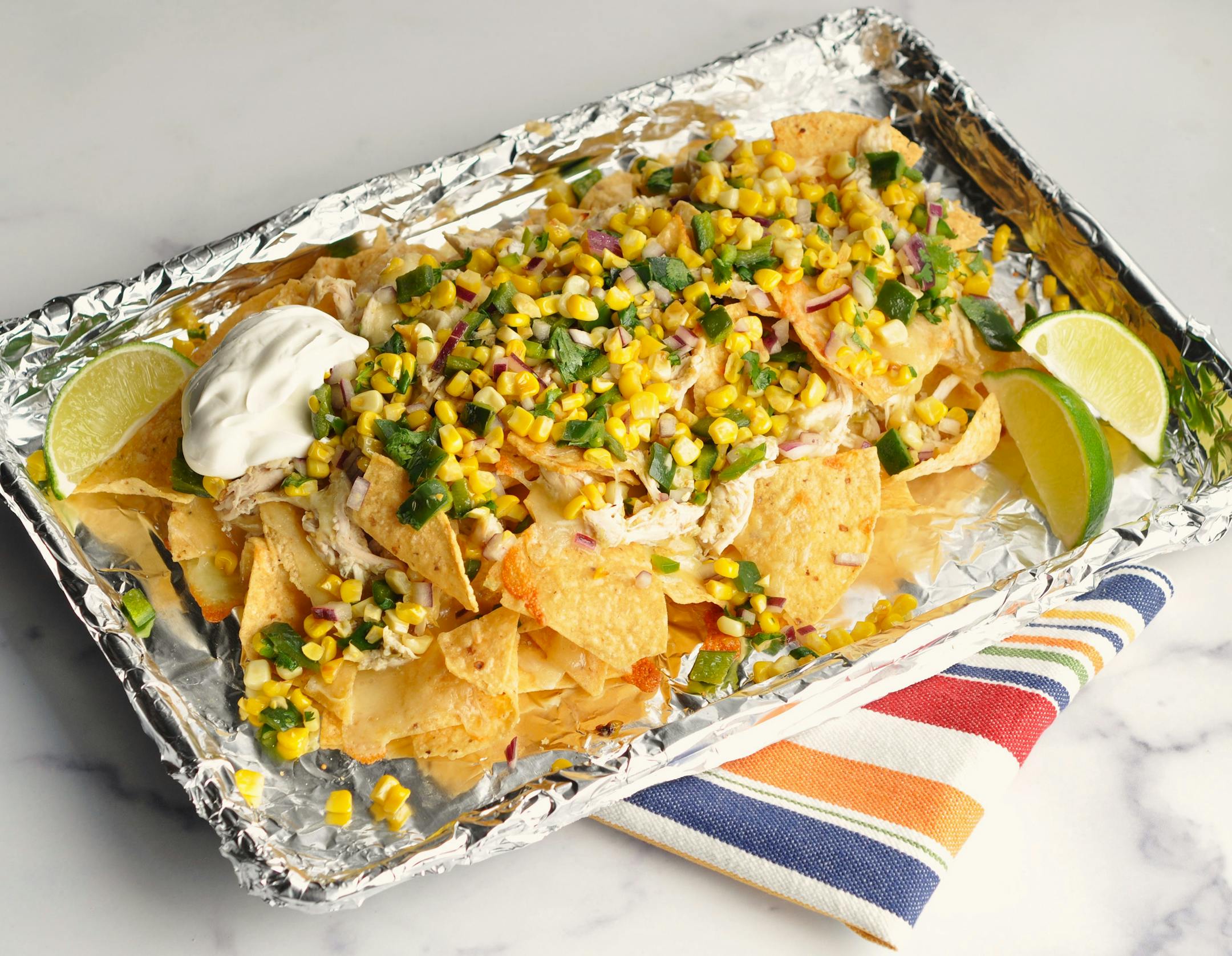 Sheet-Pan Chicken Nachos with Corn and Poblano Salsa is the ultimate gameday snack. Recipe and photo by Meredith Deeds, Special to the Star Tribune.