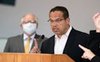 Gov. Tim Walz listened as Minnesota Attorney General Keith Ellison spoke at the press conference on Friday, May 29, about the unrest in the wake of th