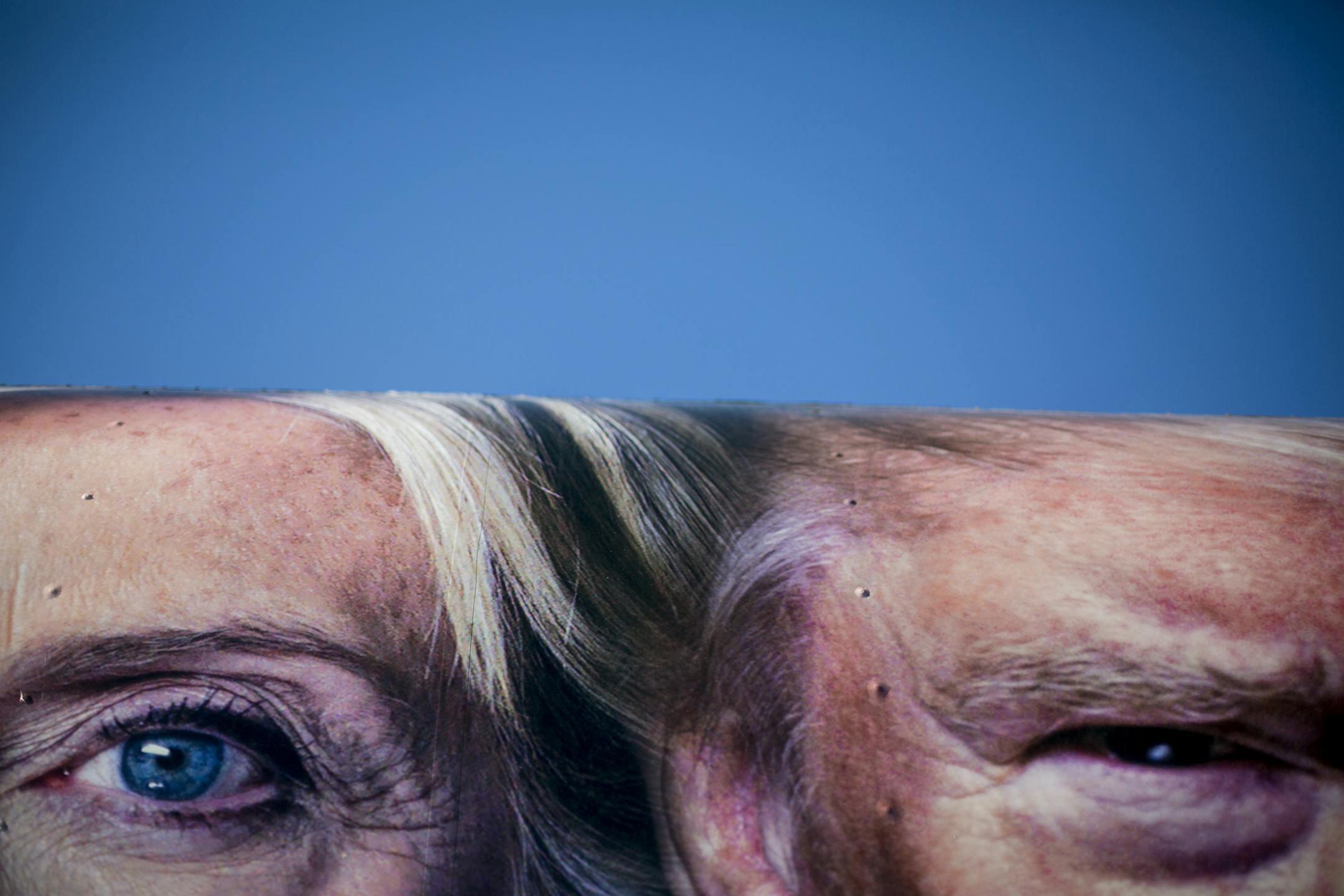 Extreme close-up images of presidential candidates Hillary Clinton and Donald Trump on the side of a CNN truck parked outside the venue for their Monday night debate, at Hofstra University in Hempstead, N.Y., Sept. 25, 2016. In a campaign that has veered from traditional policy arguments toward a more tribal battle over national identity and values, Clinton and Trump are more sharply opposed over racial and gender issues than any two presidential opponents in decades. (Sam Hodgson/The New York T