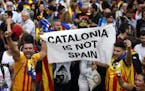 People react as they celebrate the unilateral declaration of independence of Catalonia outside the Catalan Parliament, in Barcelona, Spain, Friday, Oc