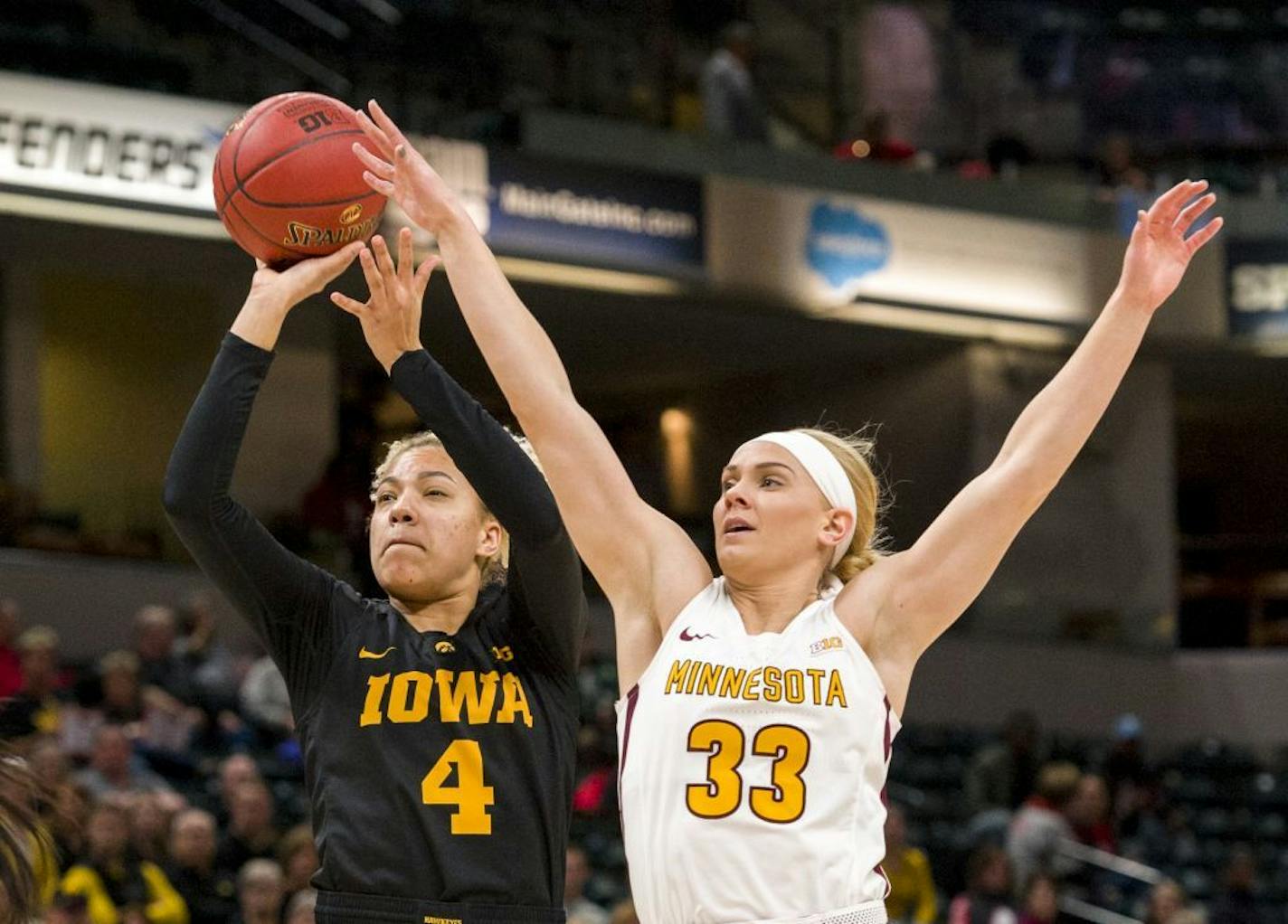 Minnesota Golden Gophers guard Carlie Wagner (33) goes after the shot of Iowa Hawkeyes forward Chase Coley (4) during the first half of a quarter-final game in the 2018 NCAA Big Ten Womens' Basketball tournament at Bankers Life Fieldhouse in Indianapolis, Friday, March 2, 2018.