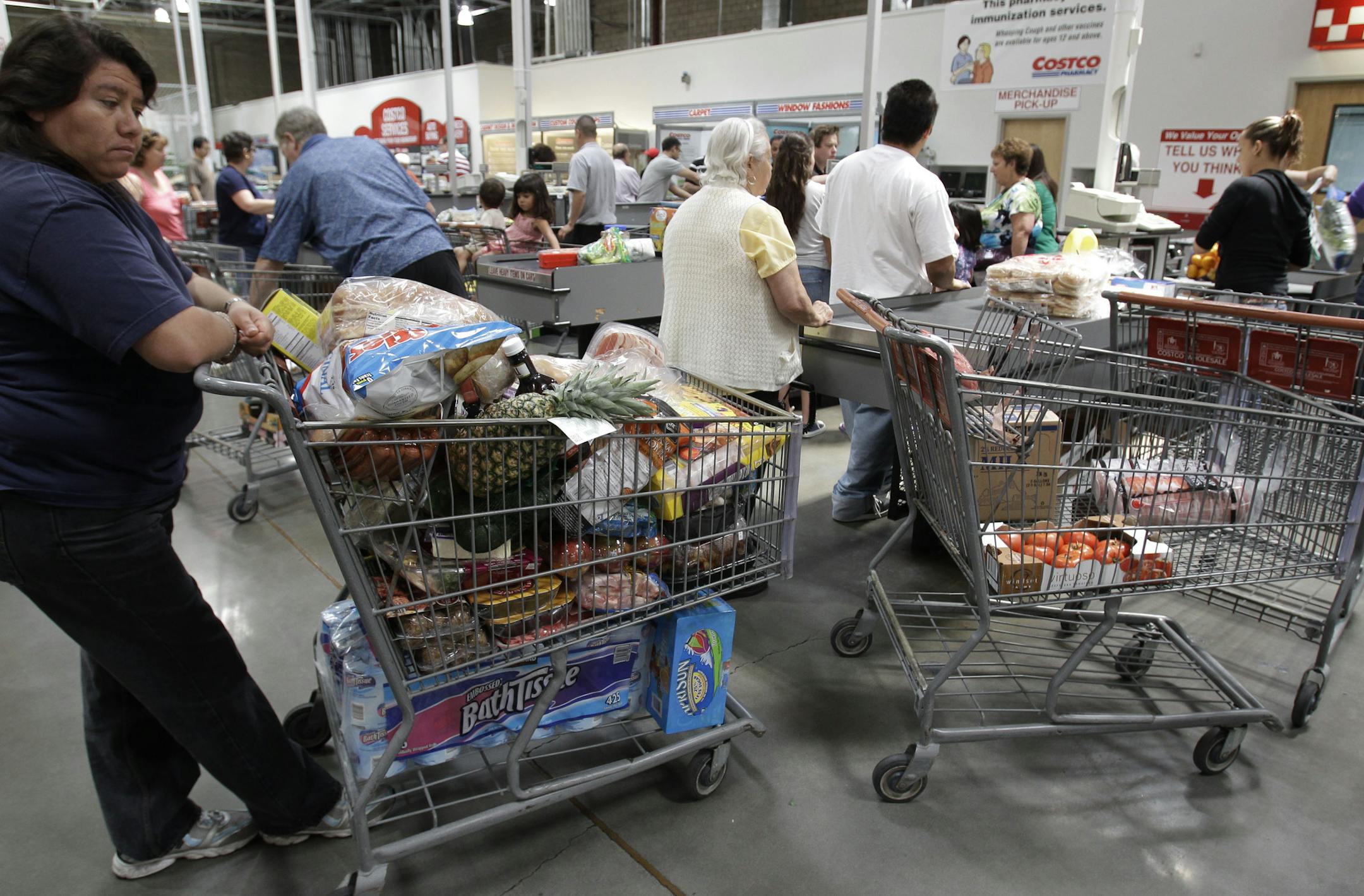 Shoppers wait in the check-out line at Costco in Mountain View, Calif., Monday, June 13, 2011. Wholesale prices rose at the slowest pace in 10 months in May as food costs fell and gas prices rose by the smallest amount in eight months. The figures suggest consumers could see some relief from rising prices soon. (AP Photo/Paul Sakuma)