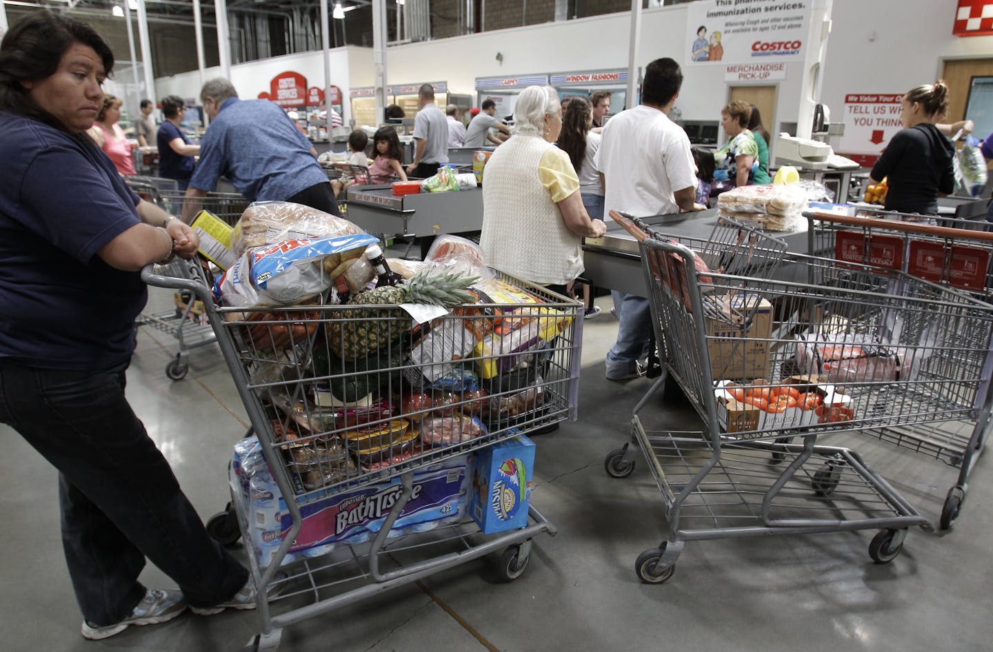 Shoppers wait in the check-out line at Costco in Mountain View, Calif., Monday, June 13, 2011. Wholesale prices rose at the slowest pace in 10 months in May as food costs fell and gas prices rose by the smallest amount in eight months. The figures suggest consumers could see some relief from rising prices soon. (AP Photo/Paul Sakuma)