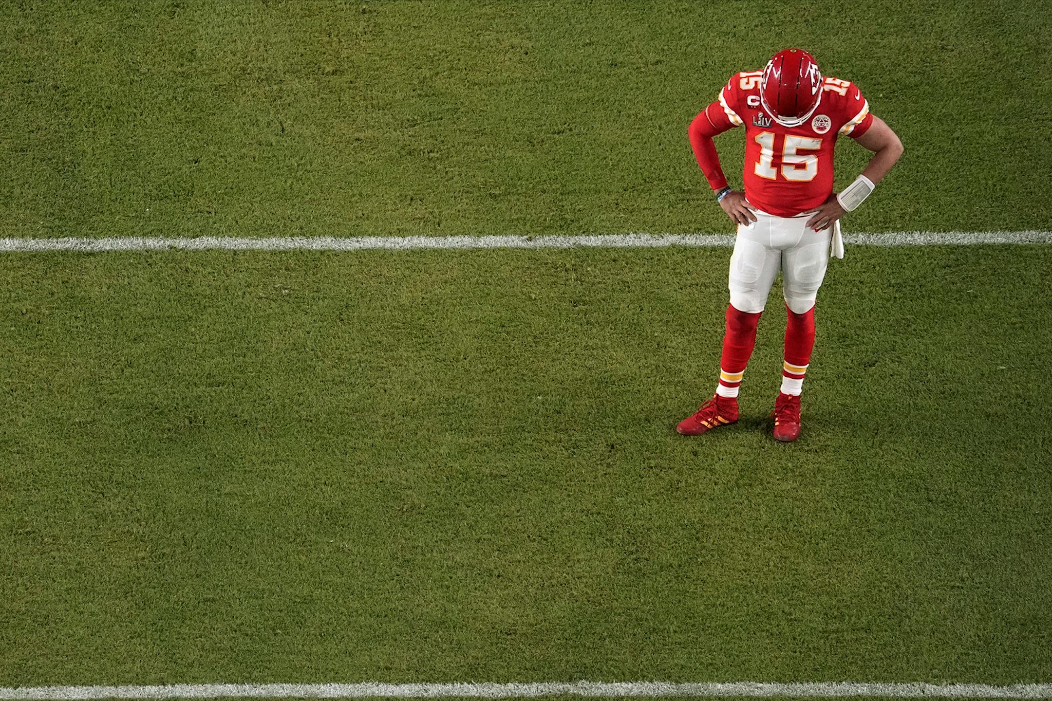 Kansas City Chiefs quarterback Patrick Mahomes (15) looks down, during the first half of the NFL Super Bowl 54 football game against the San Francisco 49ers, Sunday, Feb. 2, 2020, in Miami Gardens, Fla.