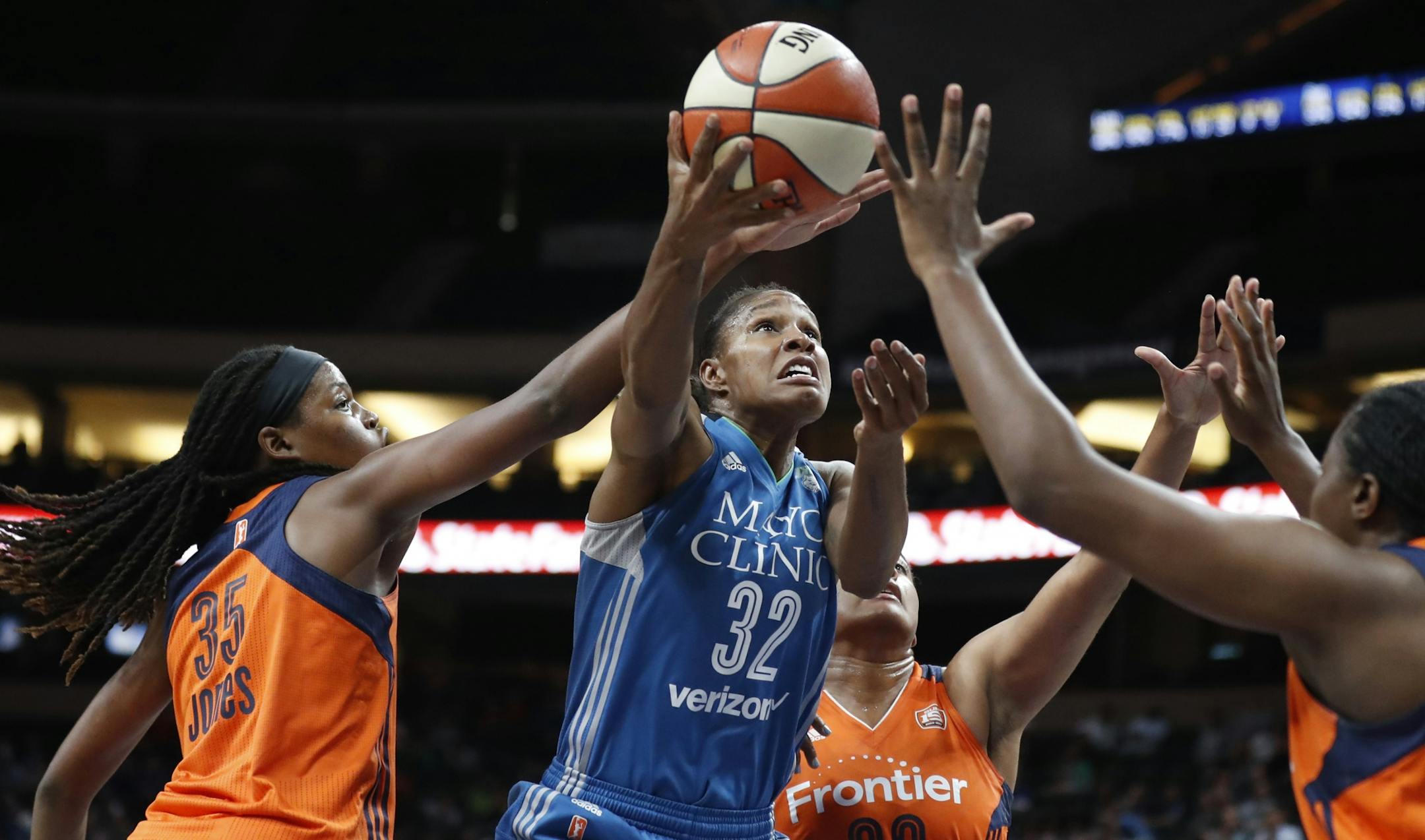 Minnesota Lynx forward Rebekkah Brunson (32) scored over Connecticut Sun forward Jonquel Jones (35) and Morgan Tuck (33) at Xcel Energy Center May 22, 2017 in St. Paul, MN.