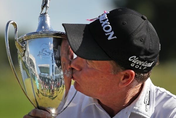 Joe Durant planted a kiss on the trophy after his playoff victory in 3M Championshionship at TPC Twin Cities on Sunday.