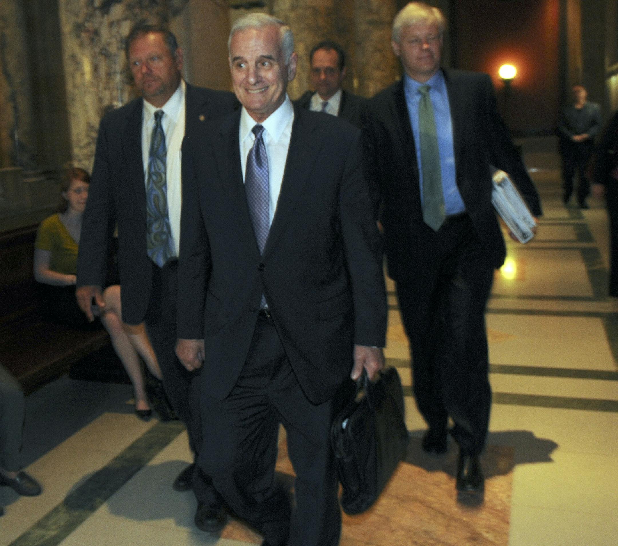 Gov. Mark Dayton and Tom Bakk Senate Minority Leader and Paul Thissen House Minority Leader walk on the way to room 237 in the State Capital to discuss the budget with GOP leadership with hopes of ending the threat of a government shutdown.