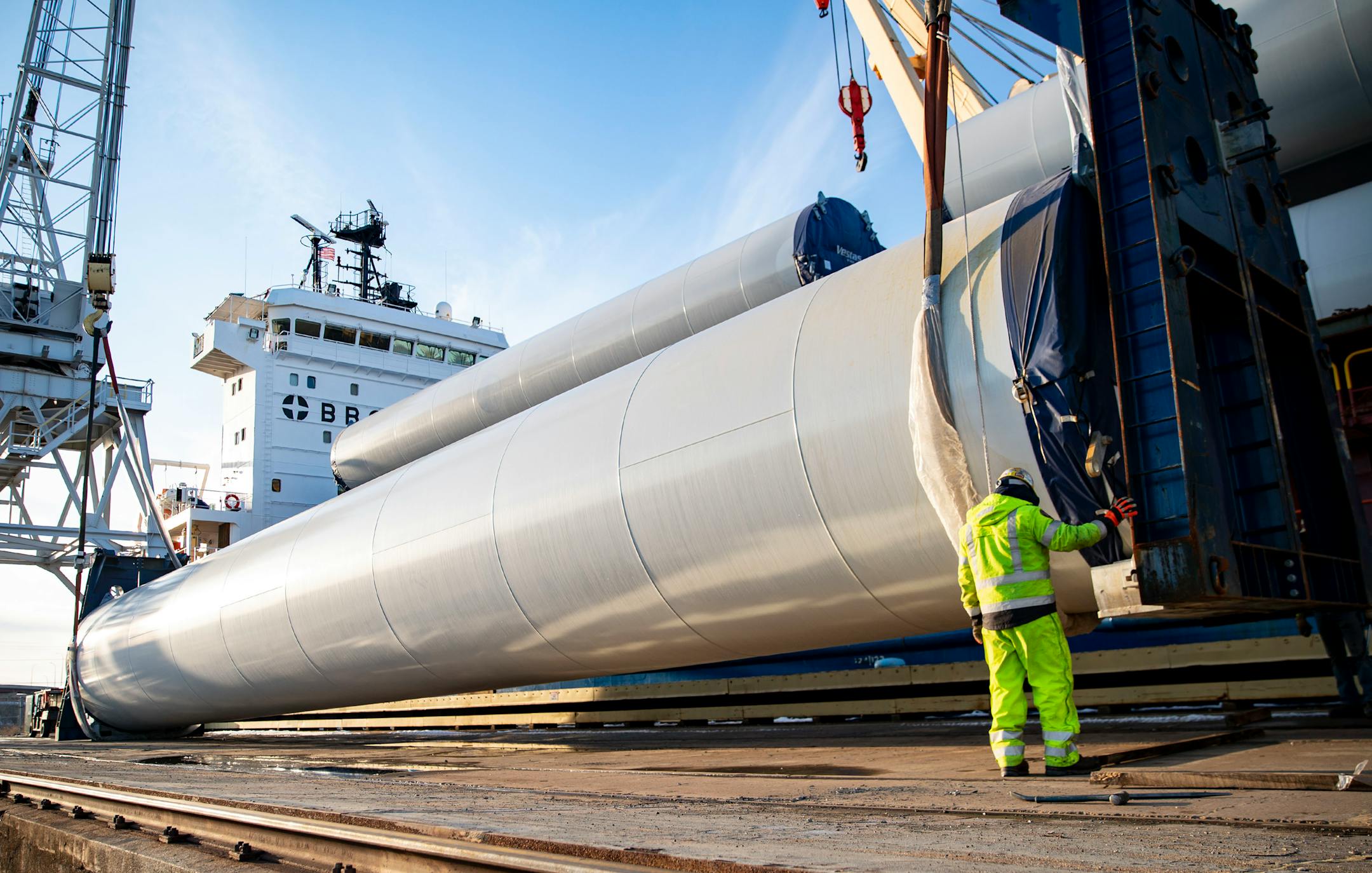 Crane operators moved a section of a wind turbine tower off the BBC Xingang and onto a flatbed truck.