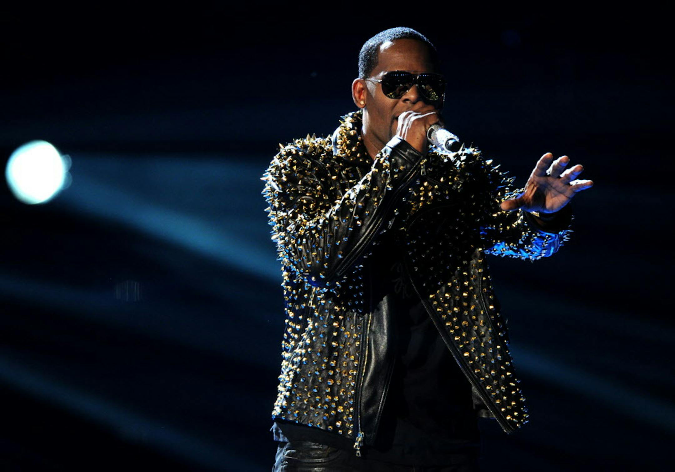 FILE - In this June 30, 2013 file photo, R. Kelly performs onstage at the BET Awards at the Nokia Theatre in Los Angeles. The owners of 5001 Flavors knew when they started the company 23 years ago they wanted to sell custom-made clothes to rap and R&B musicians. They sought out artists and record company executives at parties and music industry events. They looked in particular for up-and-coming artists. Now musicians like R. Kelly and Kid Rock are among their fans. (Photo by Frank Micelotta/Inv