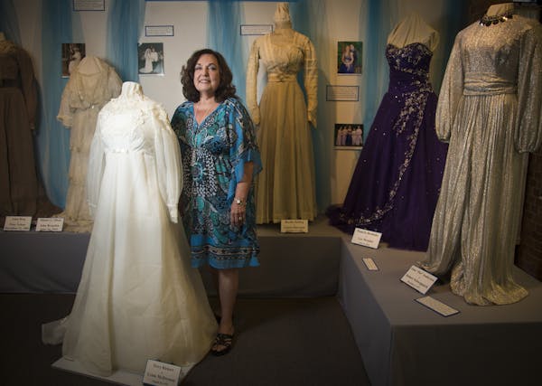 Lynn Rickert stood next to her wedding dress from 1970 that is part of an exhibit of historical wedding dresses at the Anoka County Historical Society