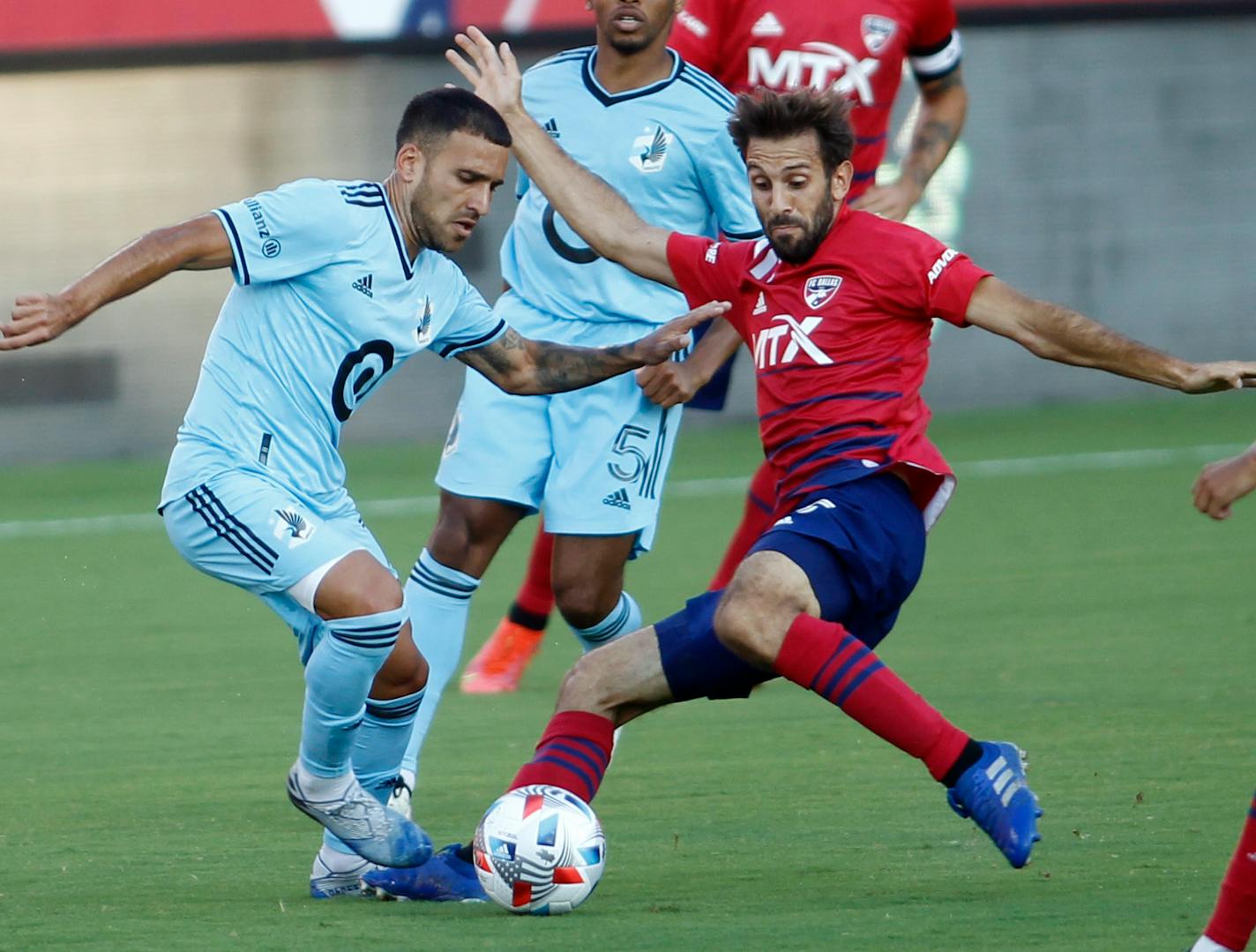 FC Dallas midfielder Fecund Quignon, right, challenges Minnesota United forward Franco Fragapane (7) for ball possession during the first half of an MLS soccer match in Frisco, Texas, Saturday, June 19, 2021. (Steve Hamm/The Dallas Morning News via AP)