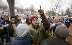 Protestors yelled profanities, flipped them off, and spit on them during a protest over the death of Jamar Clark, at the Fourth Police Precinct, Wedne