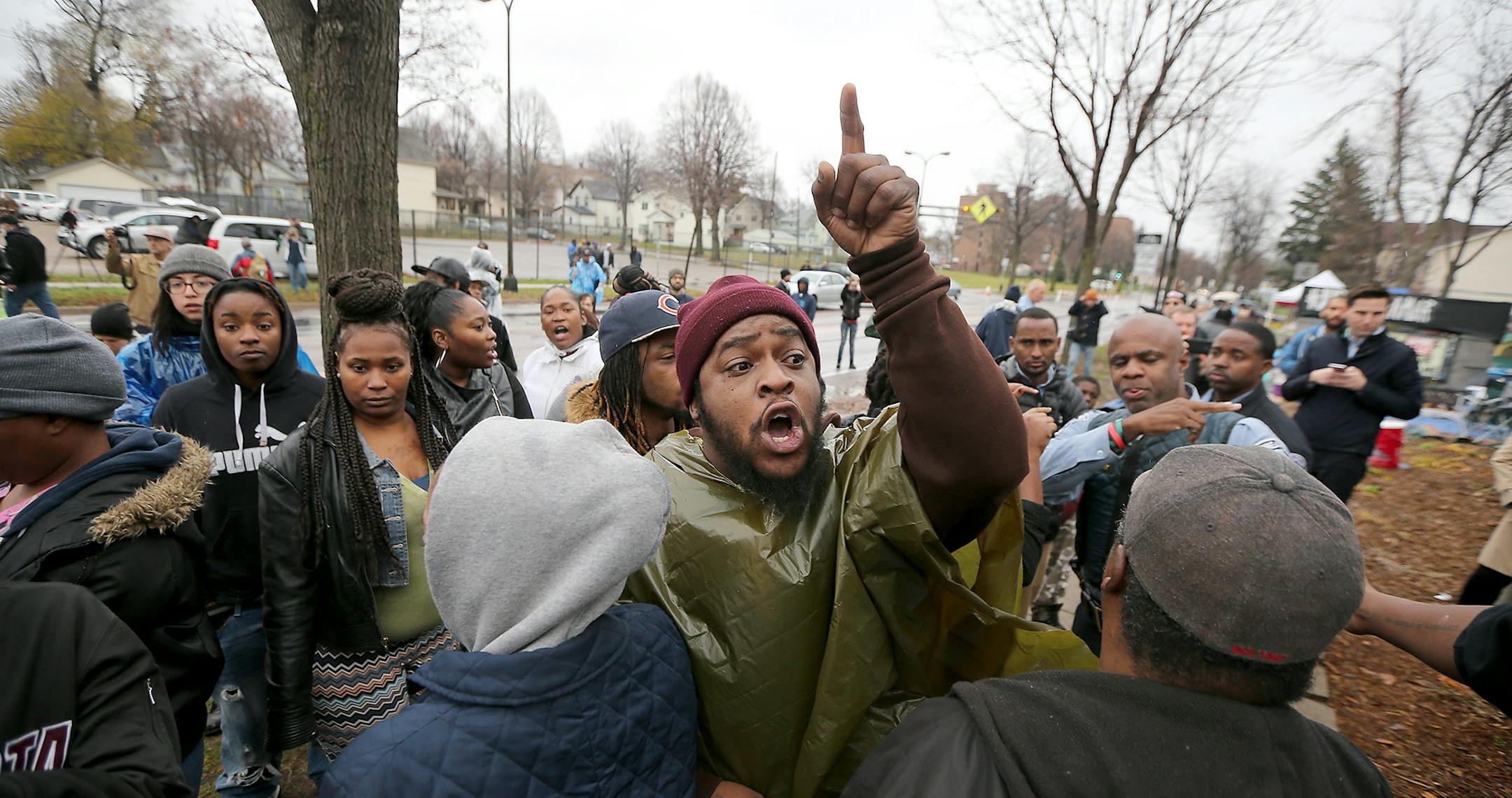 Protestors yelled profanities, flipped them off, and spit on them during a protest over the death of Jamar Clark, at the Fourth Police Precinct, Wednesday, November 4, 2015 in Minneapolis, MN. ] (ELIZABETH FLORES/STAR TRIBUNE) ELIZABETH FLORES • eflores@startribune.com