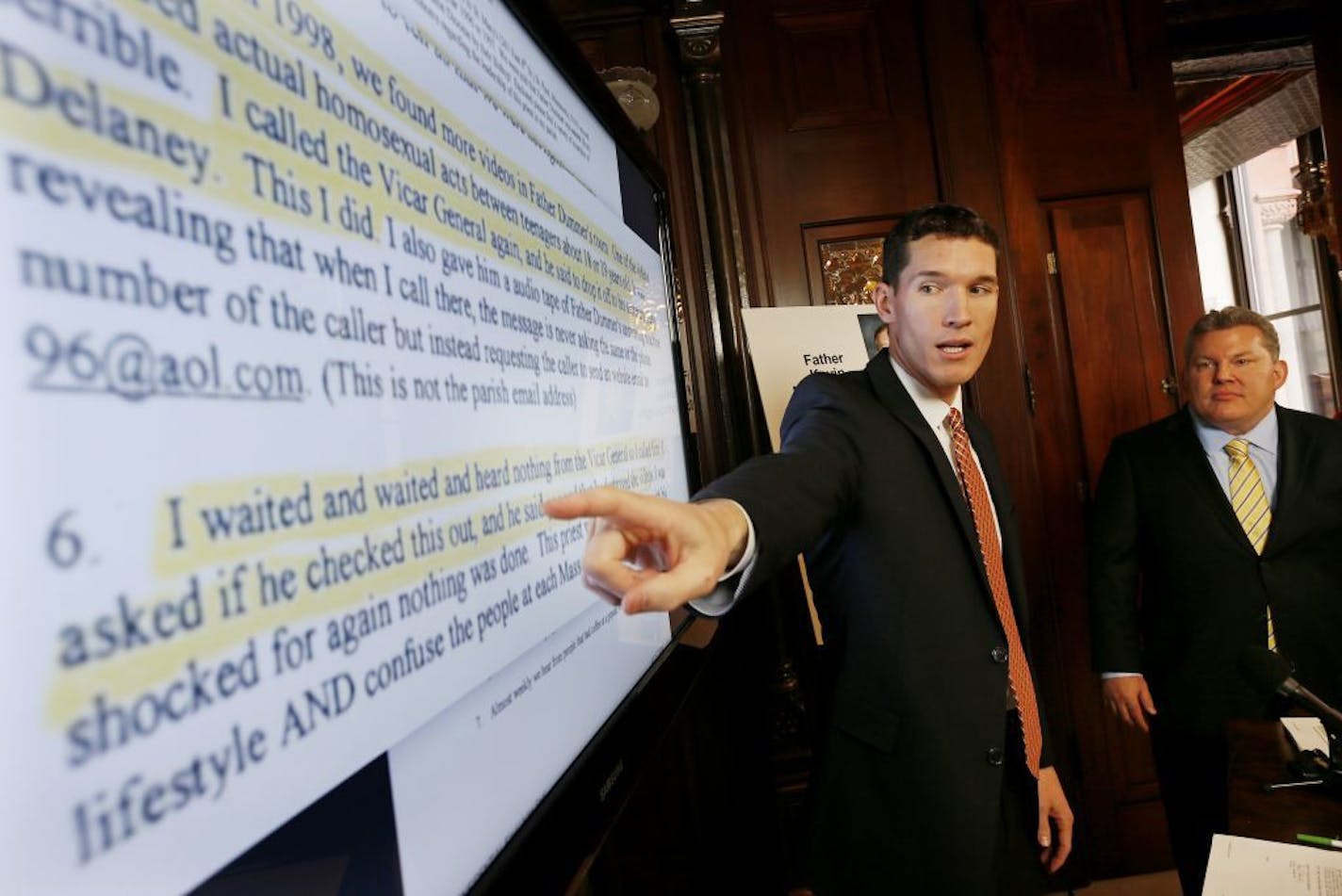 Attorney Michael G. Finnegan, left, explained documents indicating that the archdiocese was aware of a priest who was in possession of child porn but that the former vicar general, Kevin McDonough, allegedly destroyed evidence, during a press conference held Thursday, Nov. 13, 2014, in St. Paul. Standing to the right is Patrick J. Wall.