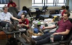 Ben Pelton, right, and Dr. Timothy Sielaff, who was assisted by Travis Wolfe of the Red Cross, donated blood at Allina Commons on March 19. State heal