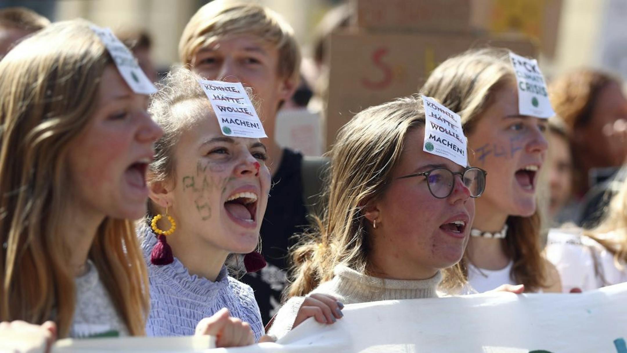 Young women attend a 'Fridays For Future' rally in Munich, Germany, Friday, Sept. 20, 2019. Protests of the 'Fridays For Future' movement against the increase of carbon dioxide emissions are planned Friday in cities around the globe. In the United States more than 800 events were planned Friday, while in Germany more than 400 rallies are expected.