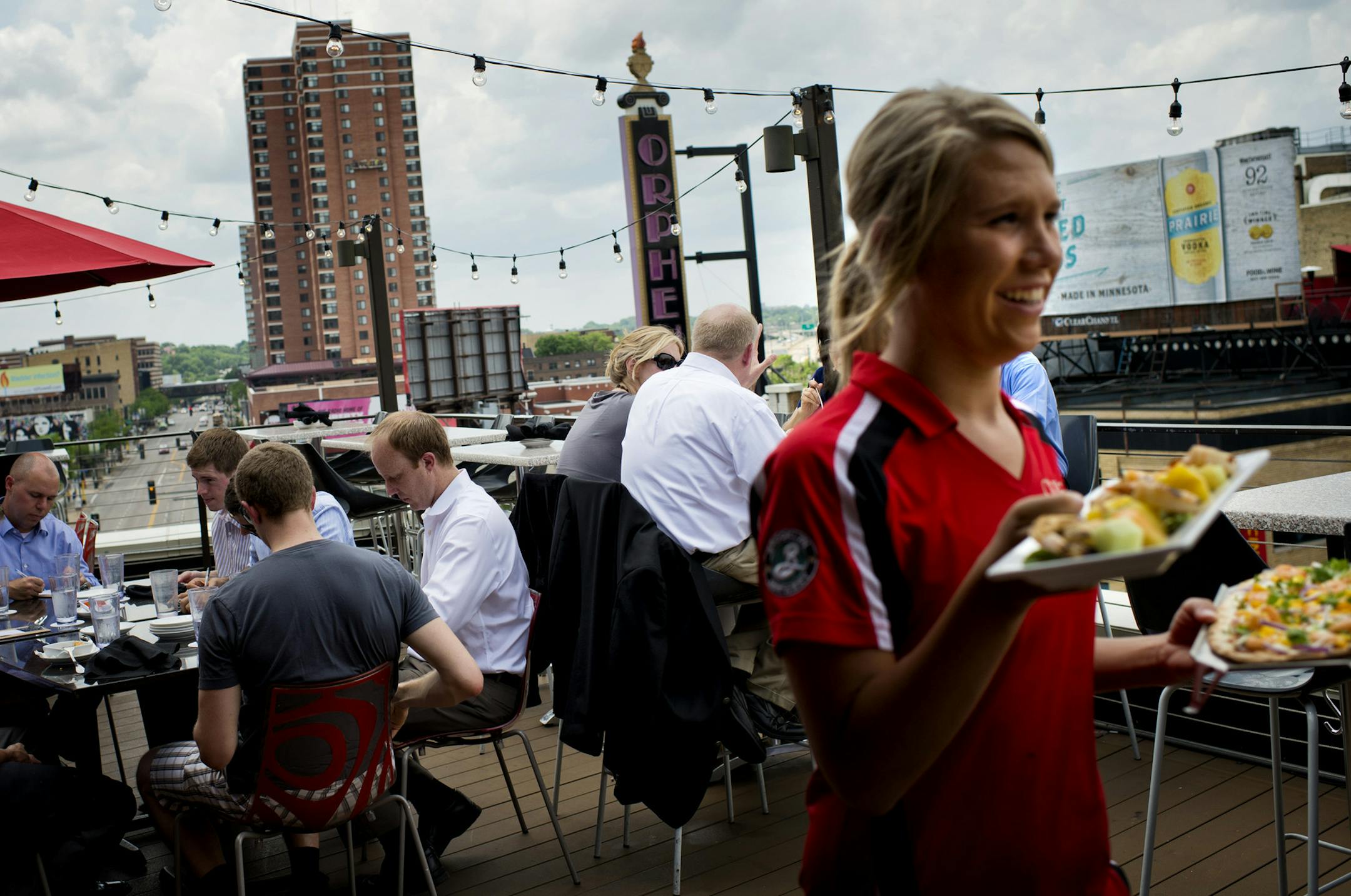 The state added 2,900 jobs in leisure and hospitality in May as winter finally waned. Here, rooftop patrons dined at Crave in Minneapolis.