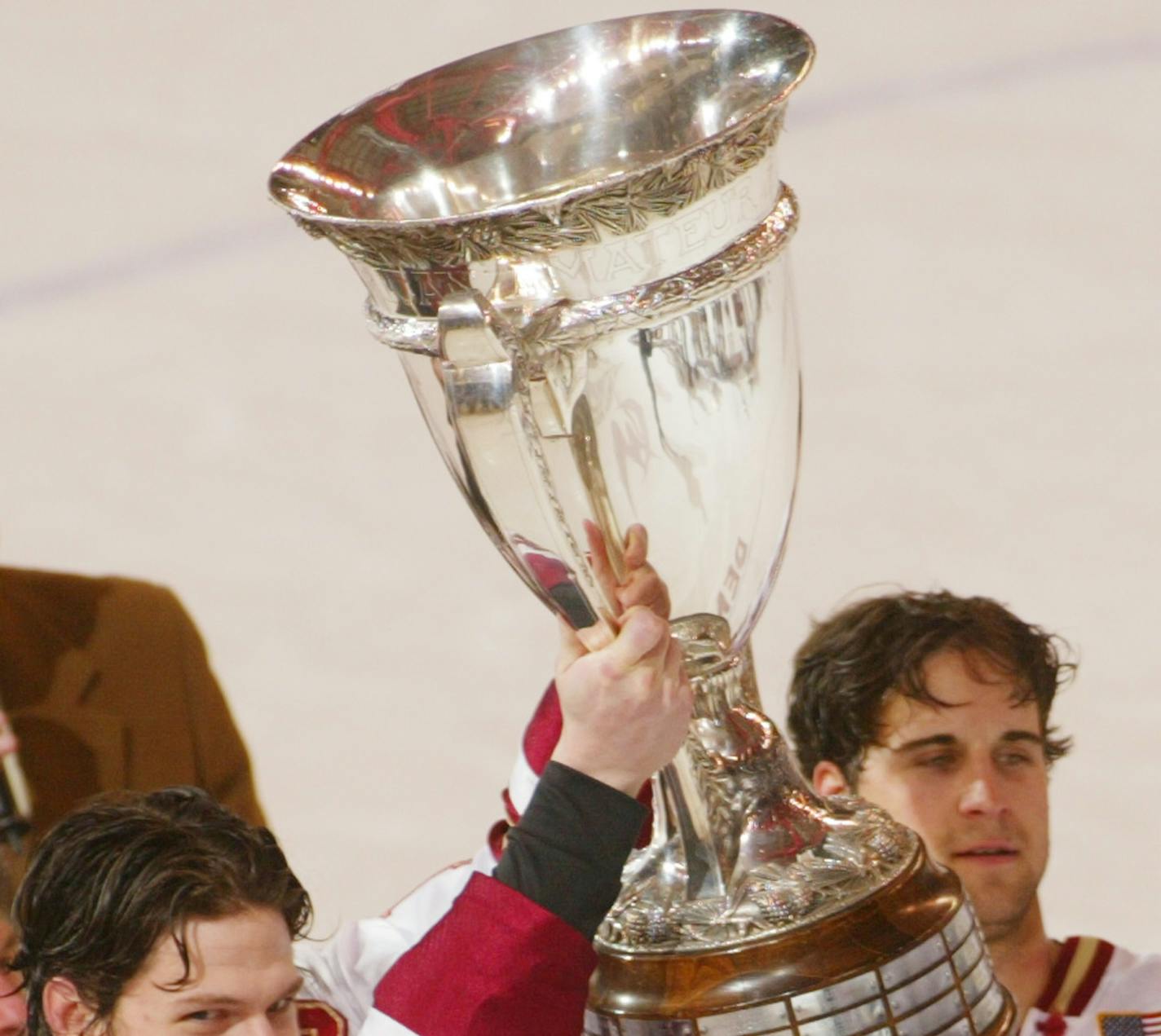 Denver captain Bryan Vines (10) and teammate Chris Paradise (18) hold the MacNaughton Cup after Denver beat Michigan Tech 8-1 to win the WCHA championship at Magness Arena in Denver, Saturday, March 9, 2002. Denver will travel to St. Paul, Minn., to compete in the NCAA Final Five tournament. (AP Photo/Jack Dempsey) ORG XMIT: COJD108