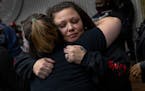 Katie Wright is hugged at a 21st birthday party for her son Wednesday, Oct. 27 at the Brooklyn Center Community Center in Brooklyn Center, Minn. Katie