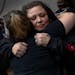 Katie Wright is hugged at a 21st birthday party for her son Wednesday, Oct. 27 at the Brooklyn Center Community Center in Brooklyn Center, Minn. Katie