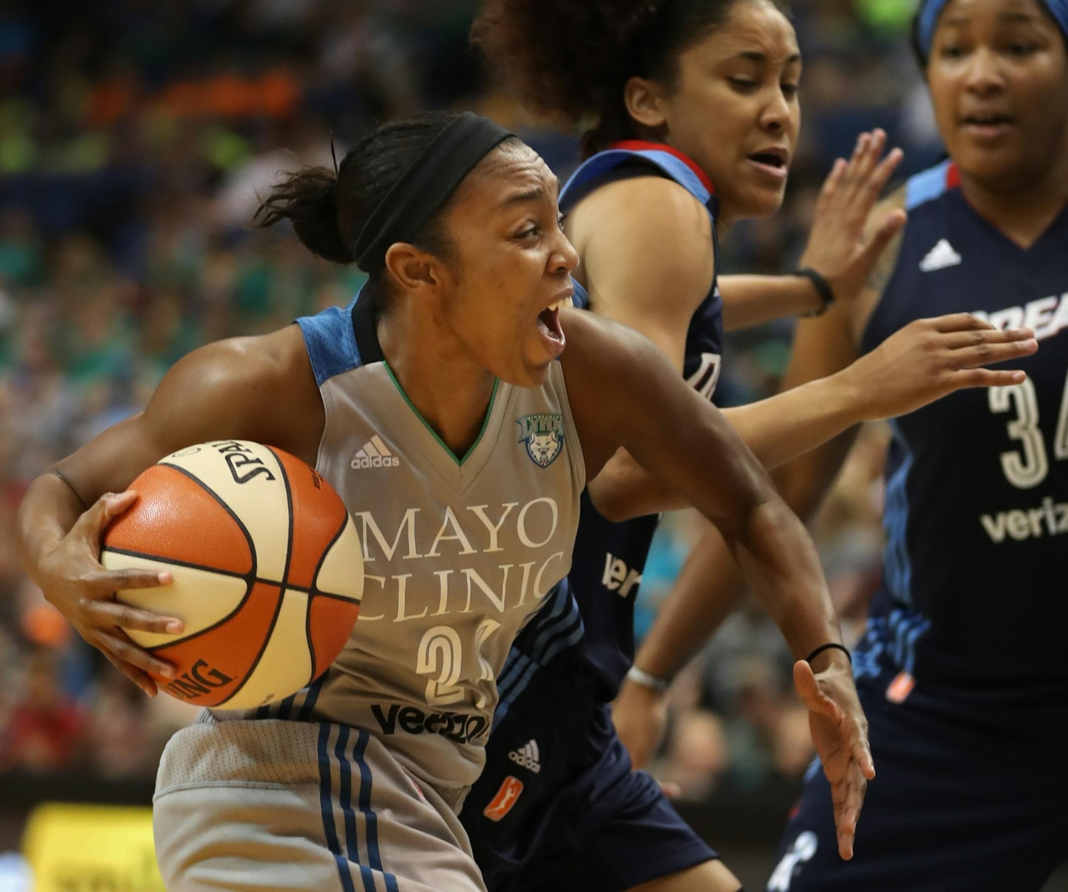 Renee Montgomery(21) makes move to the basket against Dream player Carla Cortijo(8) .