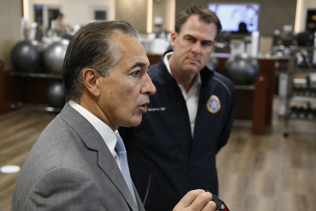 Bahram Akradi, left Life Time CEO and Oklahoma Gov. Kevin Stitt, right, talks with the media after a brief tour of the facility Friday, May 8, 2020, in Oklahoma Citty.