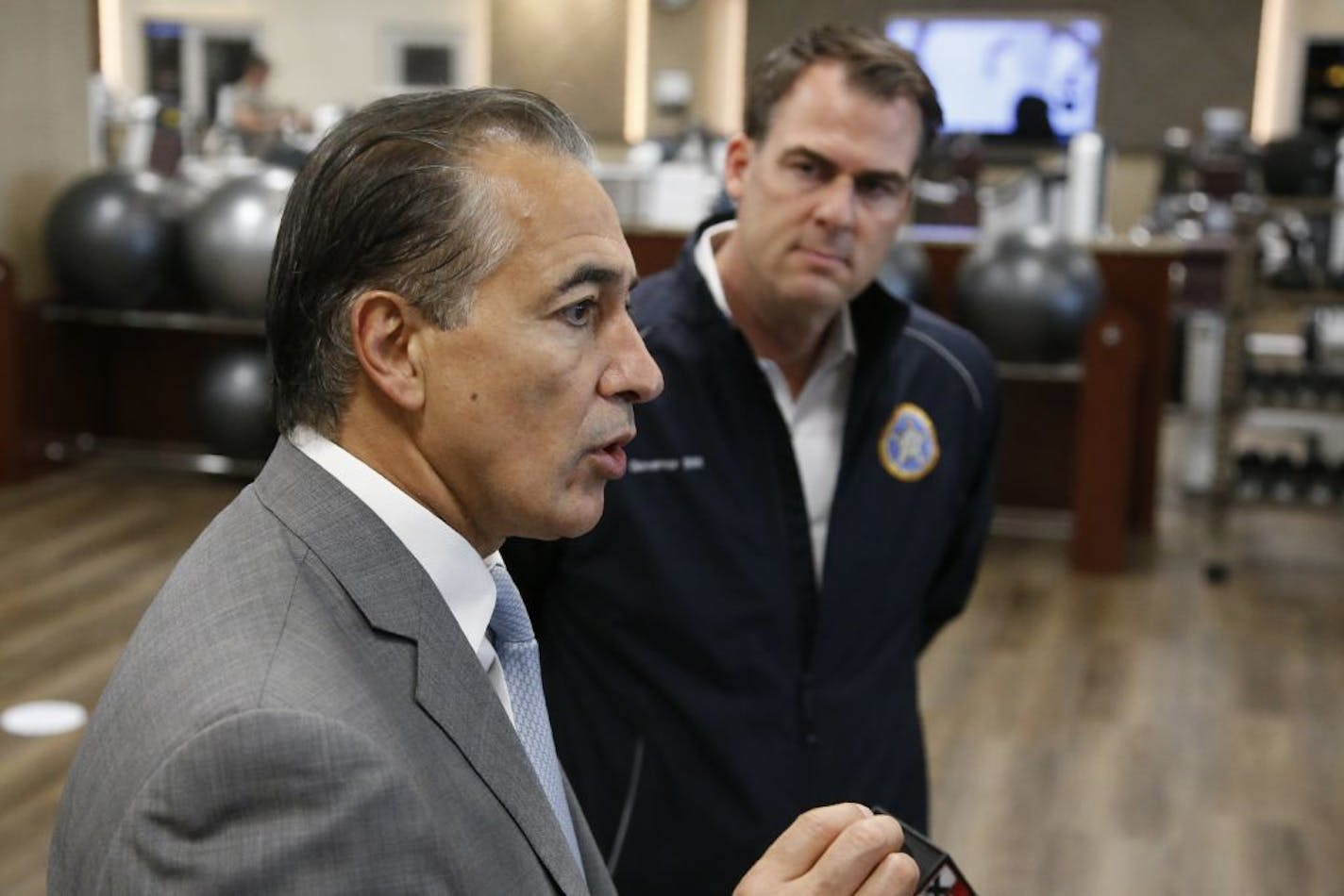 Bahram Akradi, left Life Time CEO and Oklahoma Gov. Kevin Stitt, right, talks with the media after a brief tour of the facility Friday, May 8, 2020, in Oklahoma City, as the facility reopens to the public for the first time since temporarily closing due to coronavirus concerns.