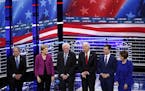 From left, Democratic presidential candidates Michael Bloomberg, Elizabeth Warren, Bernie Sanders, Joe Biden, Pete Buttigiet and Amy Klobuchar stood o