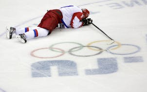 Russia forward Yevgeni Malkin lies on the ice in the closing minutes of the third period in men's quarterfinal hockey game against Finland at Bolshoy 