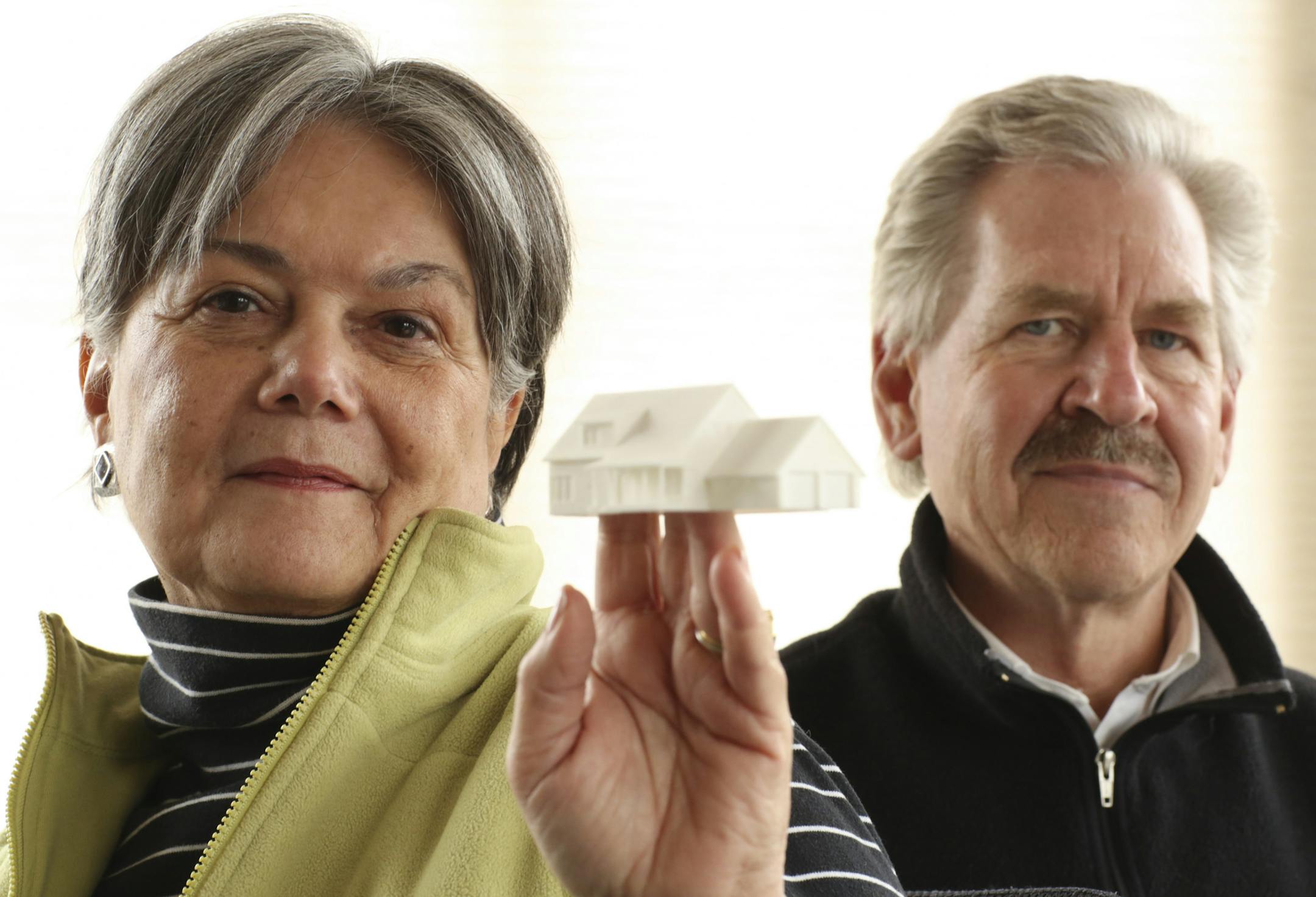 Maureen Steele Bellows and Barry Petit in their Wayzata office Wednesday afternoon. Maureen is holding a model of one of their Vernacular Revival home designs. ] JEFF WHEELER ï jeff.wheeler@startribune.com Maureen Steele Bellows and Barry Petit and their firm, SBP Design Consulting, hope to improve home design in the Twin Cities with their Vernacular Revival aesthetic and their partnership with builders. They were photographed in their Wayzata office Wednesday afternoon, April 8, 2015.