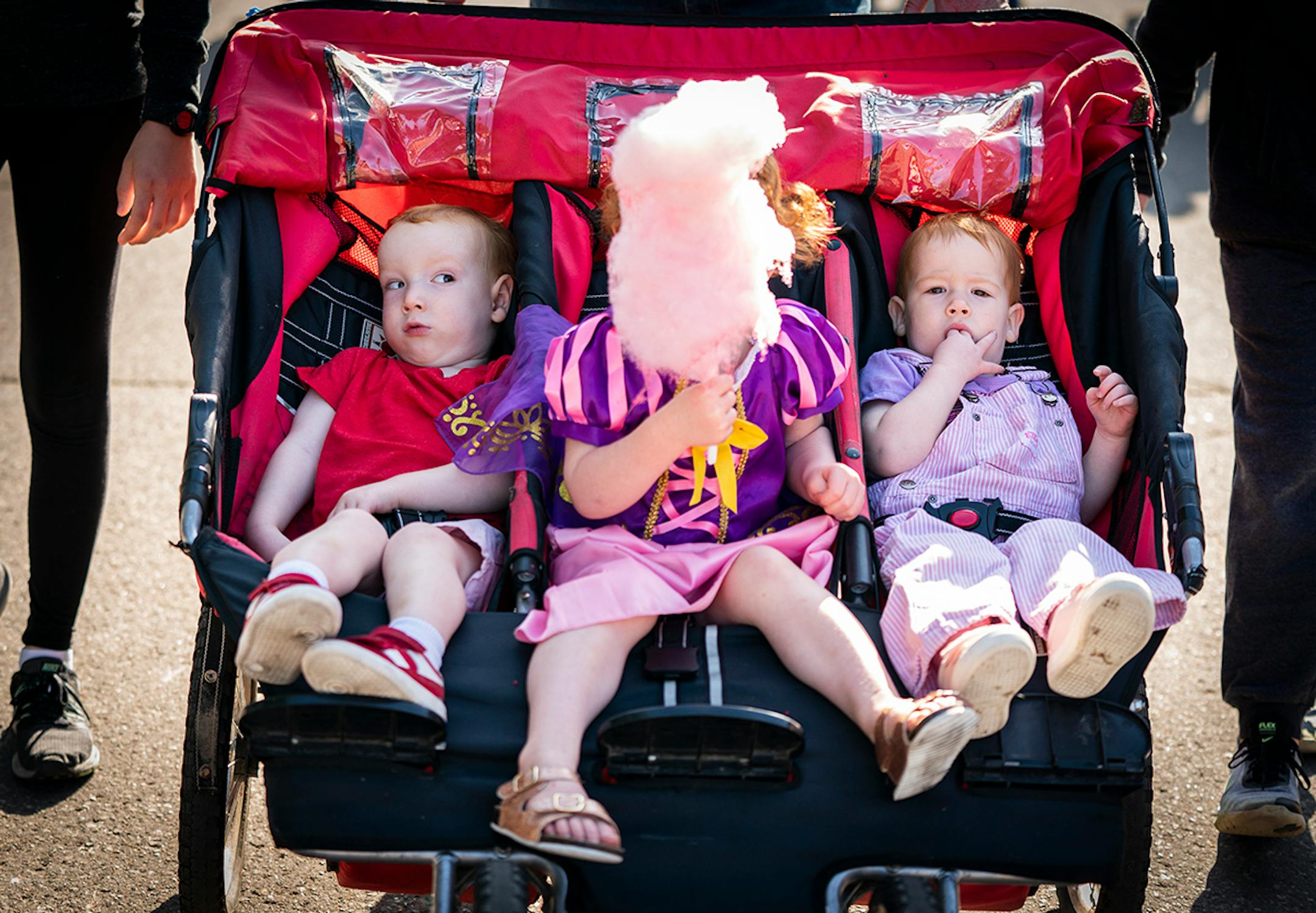 Siblings from Plymouth get the triple stroller treatment on busy Judson Avenue at the Minnesota State Fair in Falcon Heights on Friday, Aug. 23, 2019. From left are Michael Gust, 2, Monley, 3, who was enjoying some cotton candy, and Michael's twin sister, Lavinia.