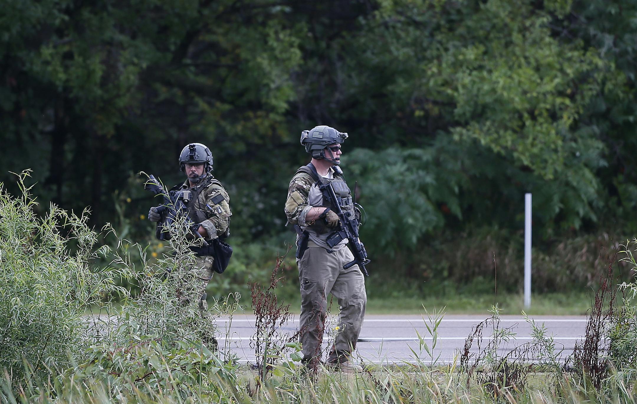 Tactical officer searched a wooded area near Mystic Lake and Little Six Casino's looking for murder suspect Ty Hoffman Wednesday September 3 , 2014 in Prior Lake MN . ] Jerry Holt Jerry.holt@startribune.com