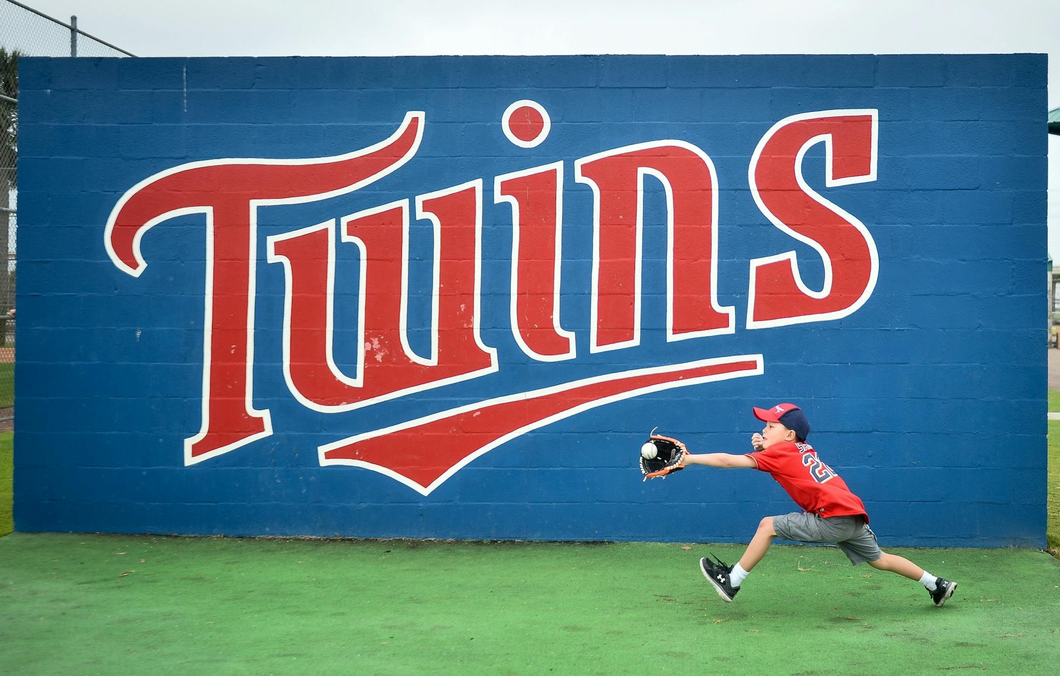 Park Hilden, 7, of Lakeville, caught a ball thrown by his father, Anthony, while the two took a break from watching Spring Training Tuesday morning at CenturyLink Sports Complex.