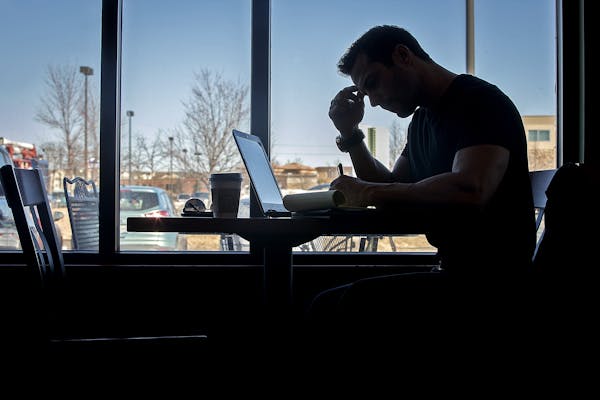 Former firefighter Brian Cristofono spent time doing homework at a coffee shop, Thursday, March 29, 2018 in Plymouth, MN. After leaving the fire depar
