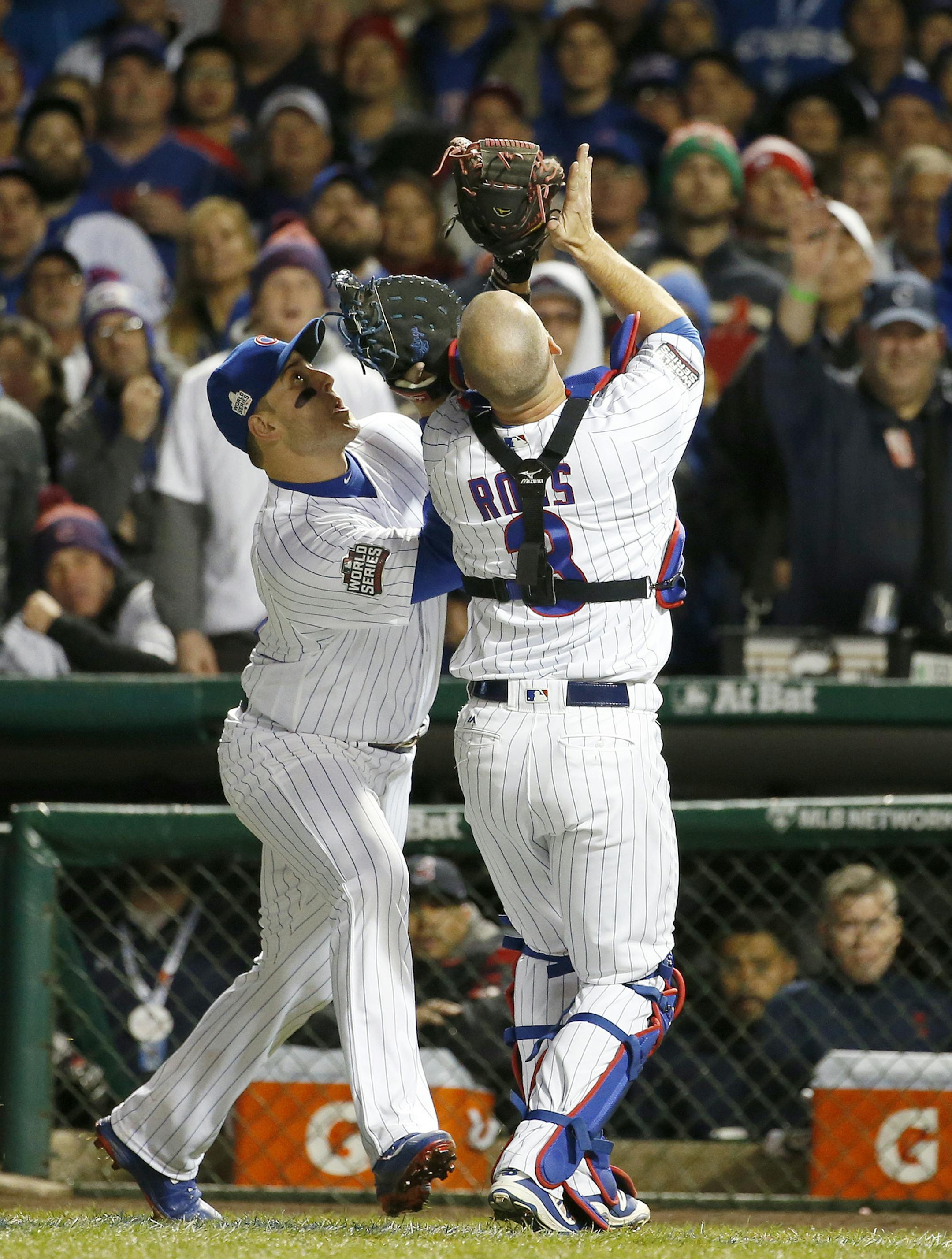 Chicago Cubs first baseman Anthony Rizzo, left, and catcher David Ross collide as Ross catches a foul ball hit by Cleveland Indians' Mike Napoli during the fourth inning of Game 5 of the Major League Baseball World Series Sunday, Oct. 30, 2016, in Chicago. (AP Photo/Nam Y. Huh)