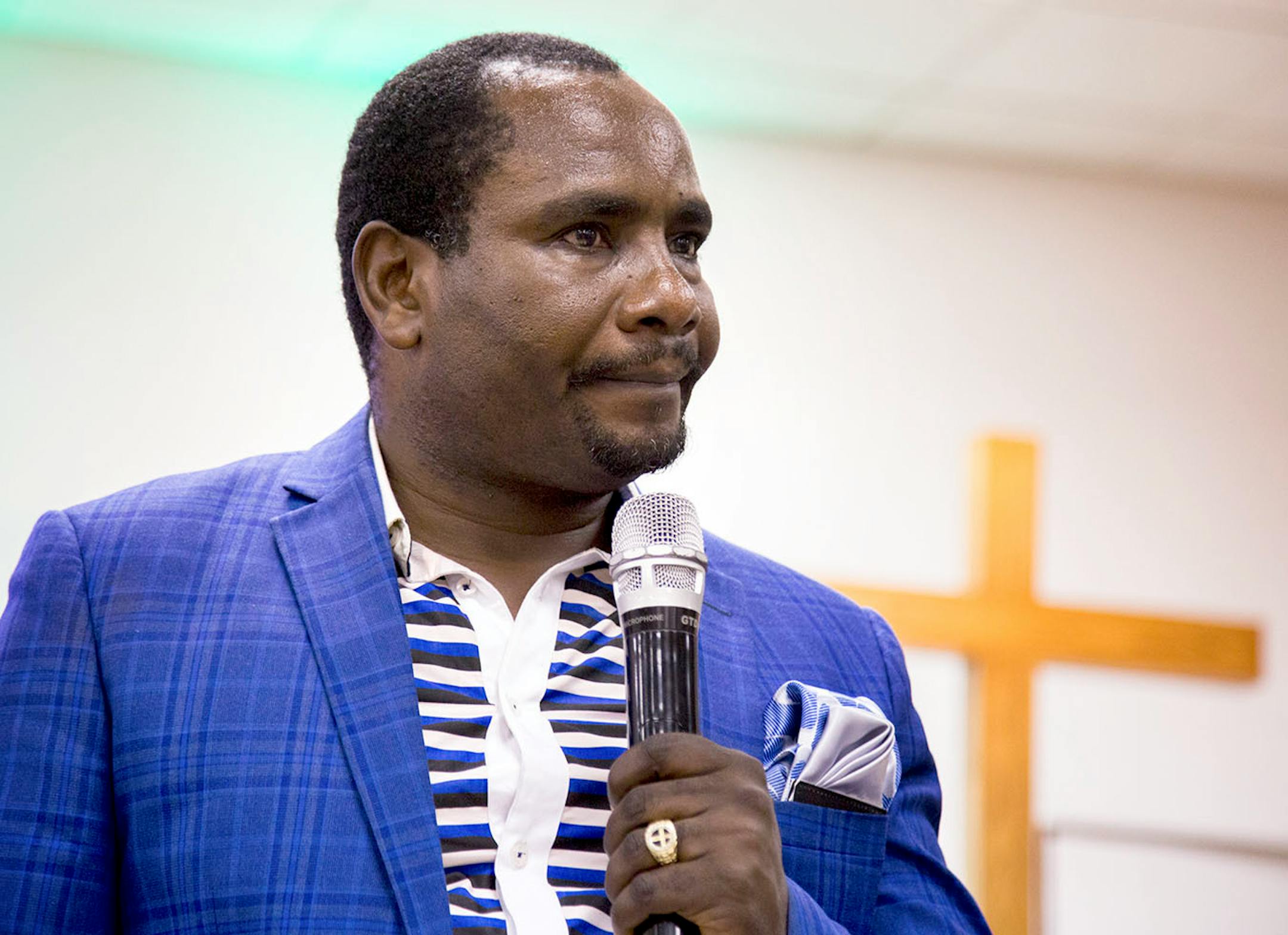 Justin Byakweli preaches during the church service for African refugees, on Sunday evening.