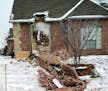 In this Dec. 29, 2015 photo, remains of a collapsed chimney rest on the ground outside a home in Edmond, Okla., following an earthquake.